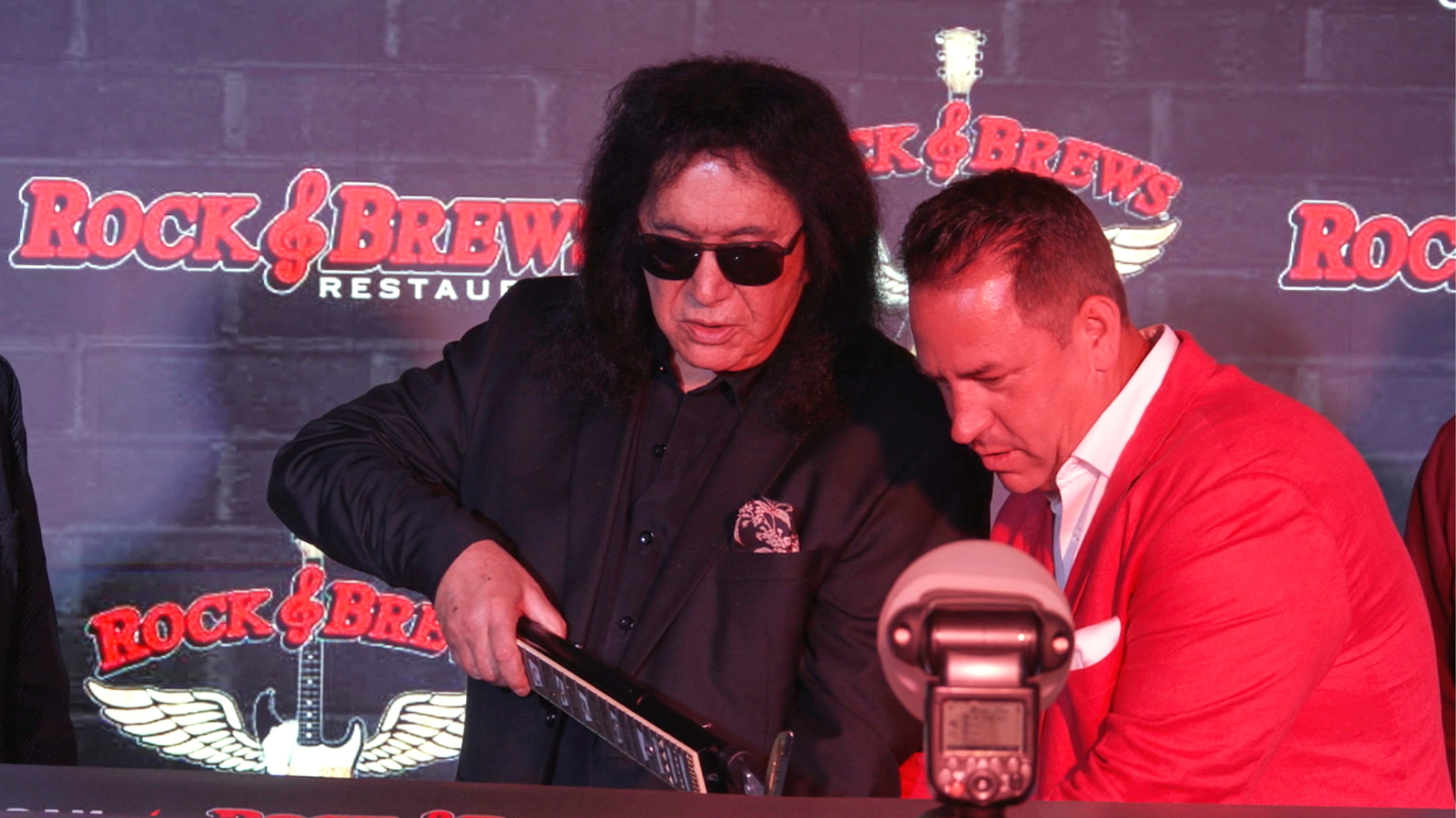 In this image taken from video, KISS frontman Gene Simmons appears with co-franchise owner Danny Yezbick at a ribbon cutting ceremony for Rock & Brews restaurant in Royal Oak, Mich., on Thursday, April 9, 2026. (AP Photo/Mike Householder)