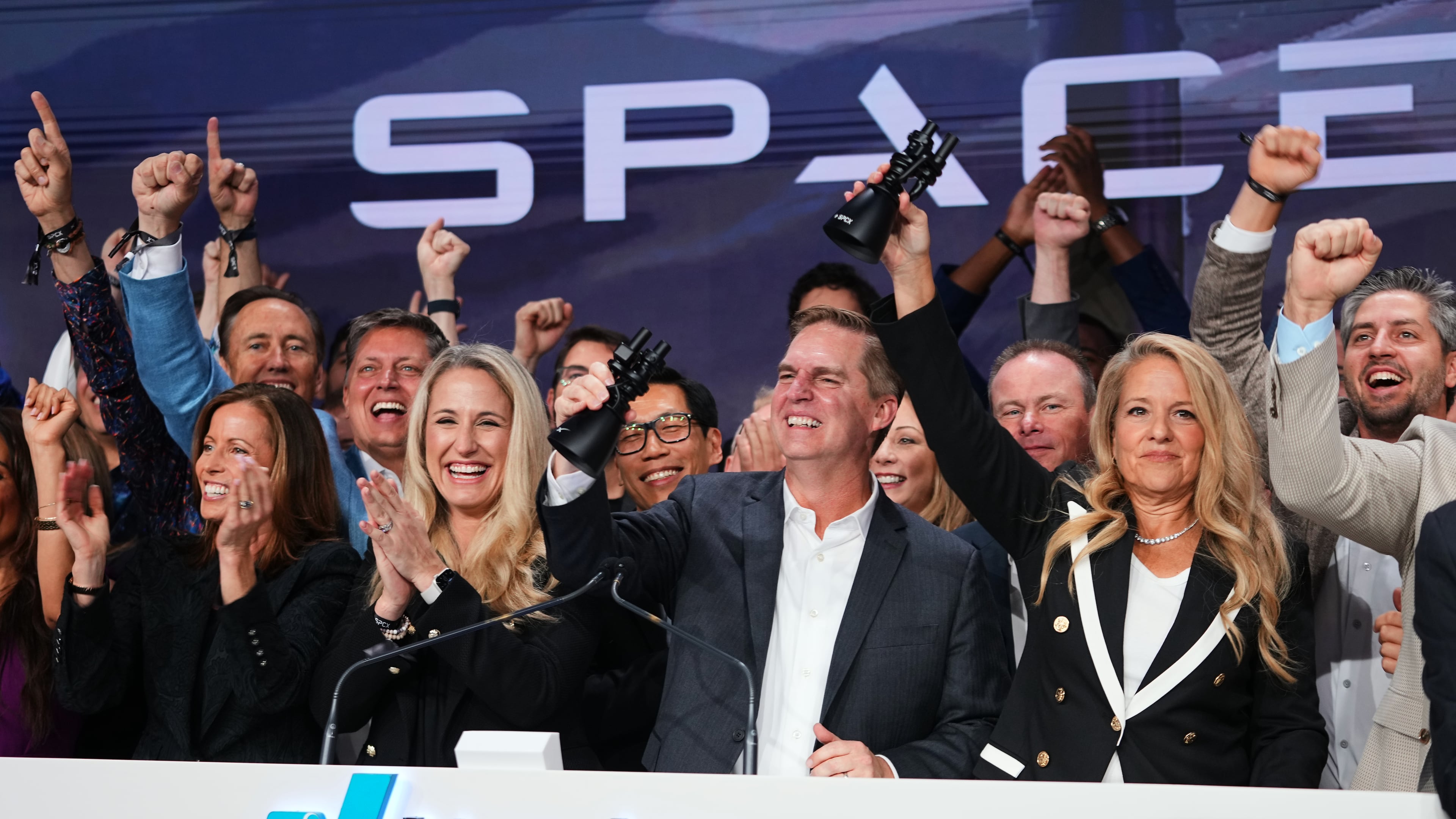 Gwynne Shotwell, President and COO of SpaceX, right, celebrates with colleagues during a bell ringing ceremony for the IPO of SpaceX at the Nasdaq MarketSite in New York, Friday, June 12, 2026, in New York. (AP Photo/Frank Franklin II)