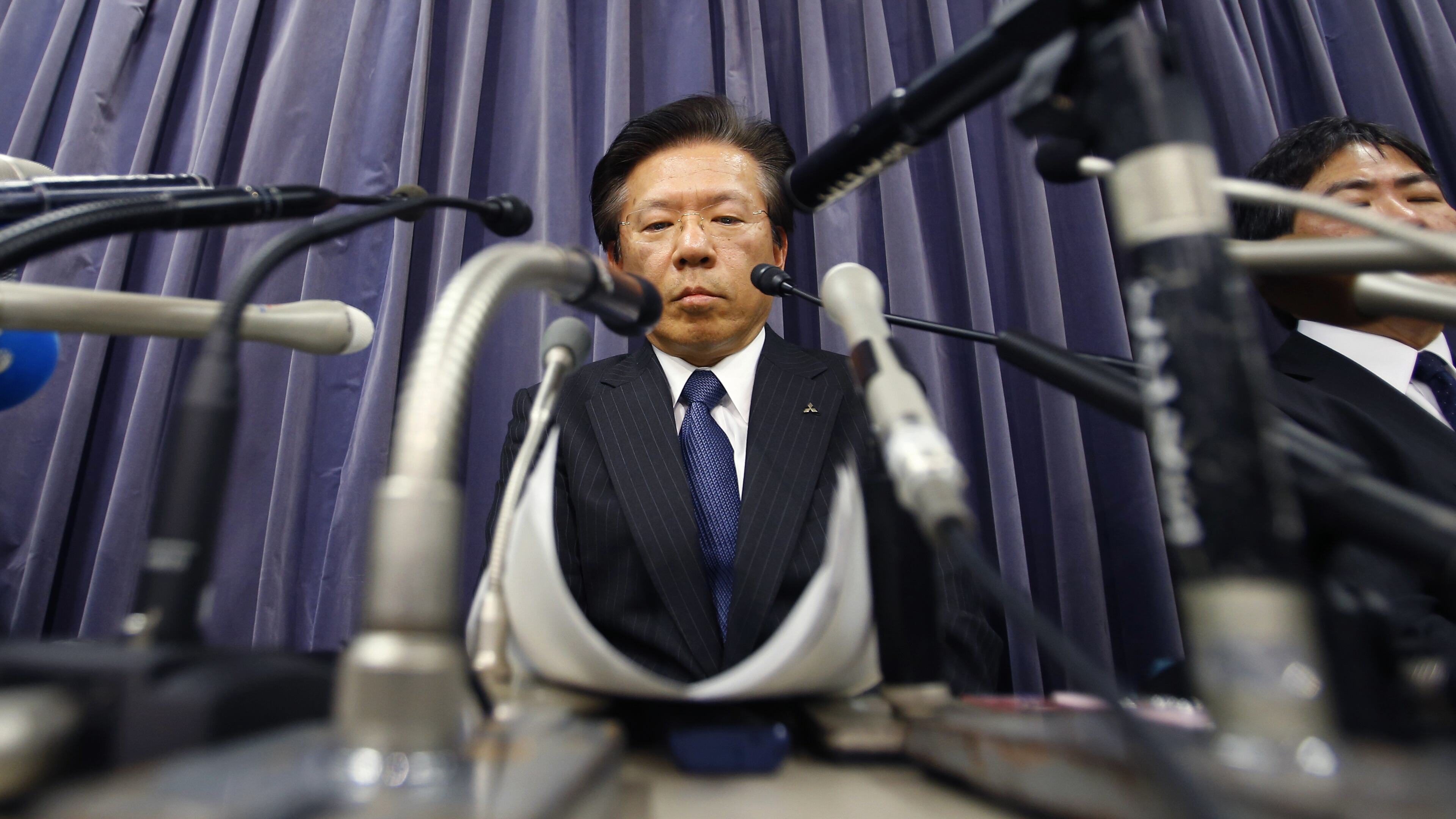 Mitsubishi Motors Corp. President Tetsuro Aikawa listens to a reporter's question during a press conference in Tokyo, Tuesday, April 26, 2016. Mitsubishi Motors, the Japanese automaker that acknowledged last week that it had intentionally lied about fuel economy data for some of its models, said an internal investigation found such tampering dated back to 1991. Aikawa told reporters Tuesday the probe was ongoing, suggesting that more irregularities might be found. (AP Photo/Shizuo Kambayashi)
