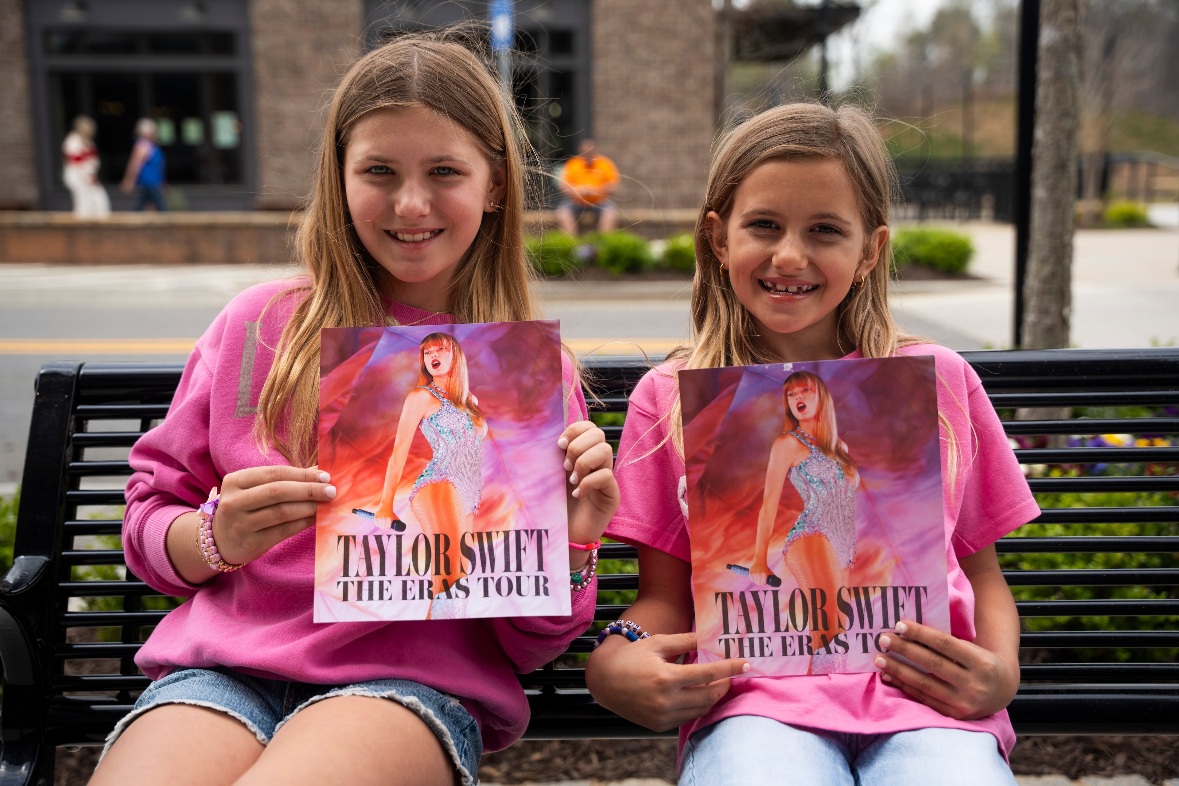 Ava Brooks, age 7 (right), and her sister Ella Brooks, age 10, wait for "Taylor Swift," Michelle Paget moonlighting as a Taylor Swift impersonator, to arrive at Roxy Moxy Boutique in Cumming, Georgia on Saturday, March 29, 2025. (Olivia Bowdoin for the AJC).