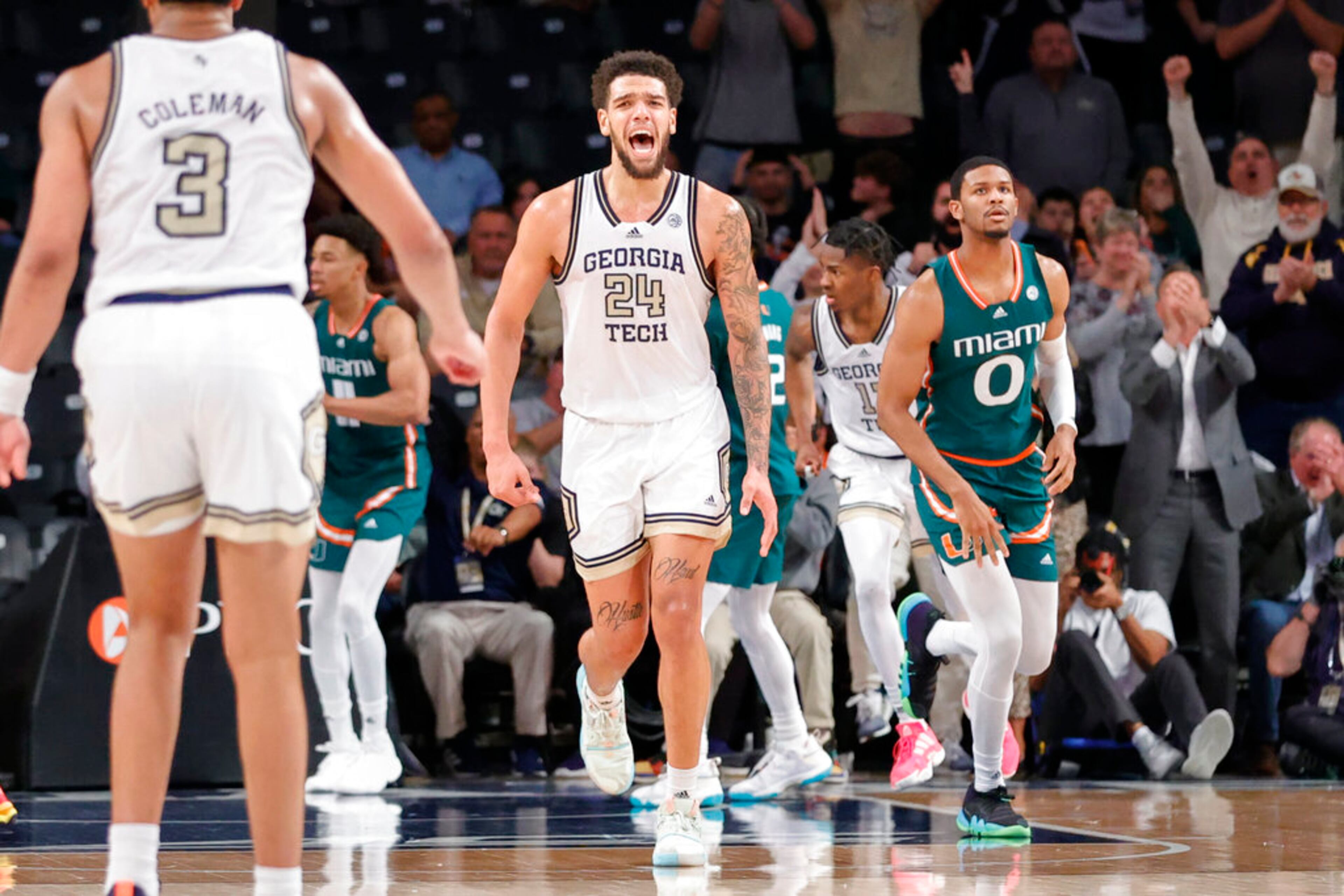 Georgia Tech center Rodney Howard, center, celebrates near Miami forward AJ Casey, right, during the second half of an NCAA college basketball game Wednesday, Jan. 4, 2023, in Atlanta. Georgia Tech won 76-70. (AP Photo/Alex Slitz)