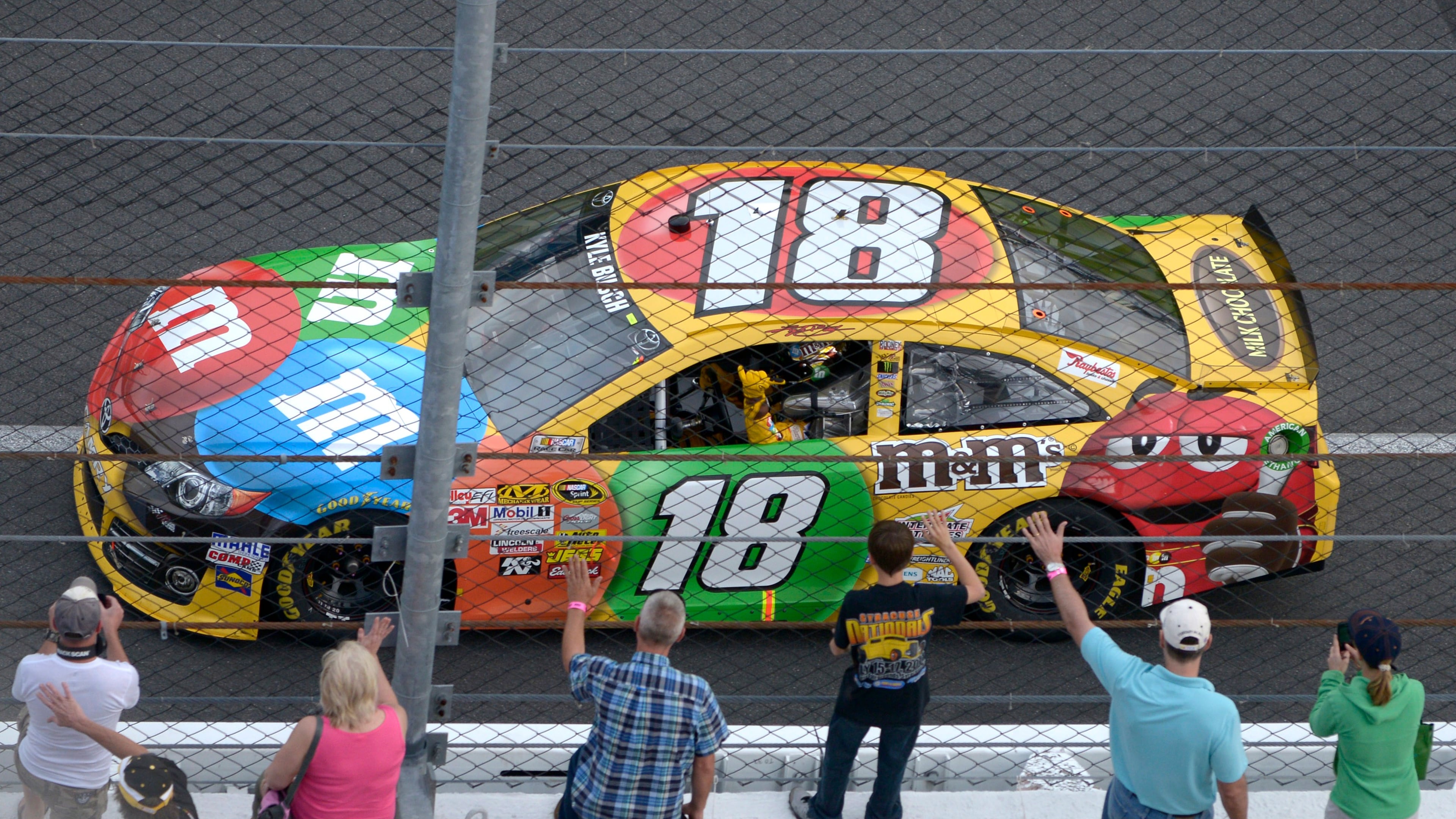 FILE - Kyle Busch waves to fans while doing a victory lap after winning the second of two 150-mile qualifying races for Sunday's NASCAR Daytona 500 auto race at Daytona International Speedway in Daytona Beach, Fla., Feb. 21, 2013. (AP Photo/Phelan M. Ebenhack, File)