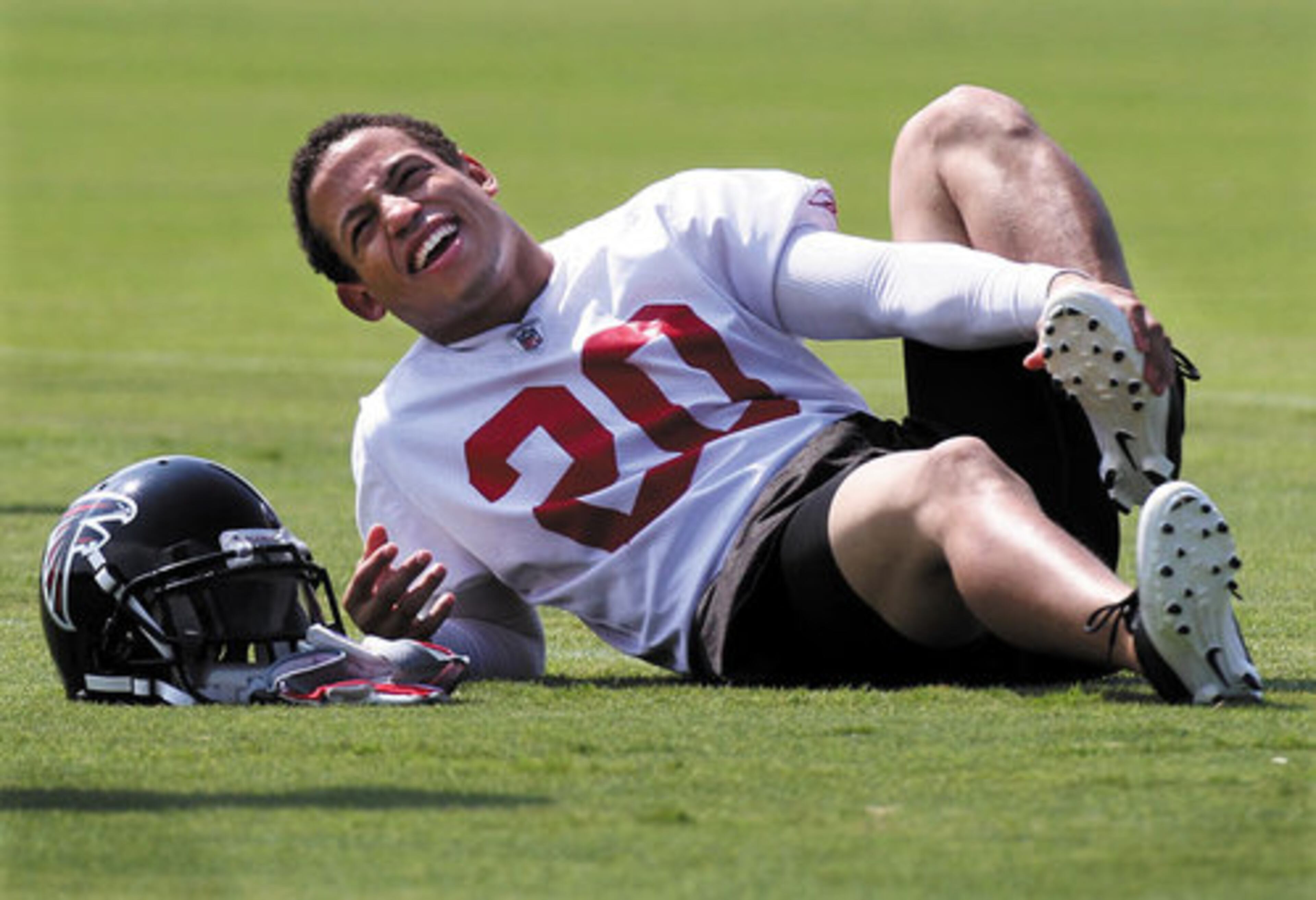 Cornerback Brent Grimes smiles as he stretches.