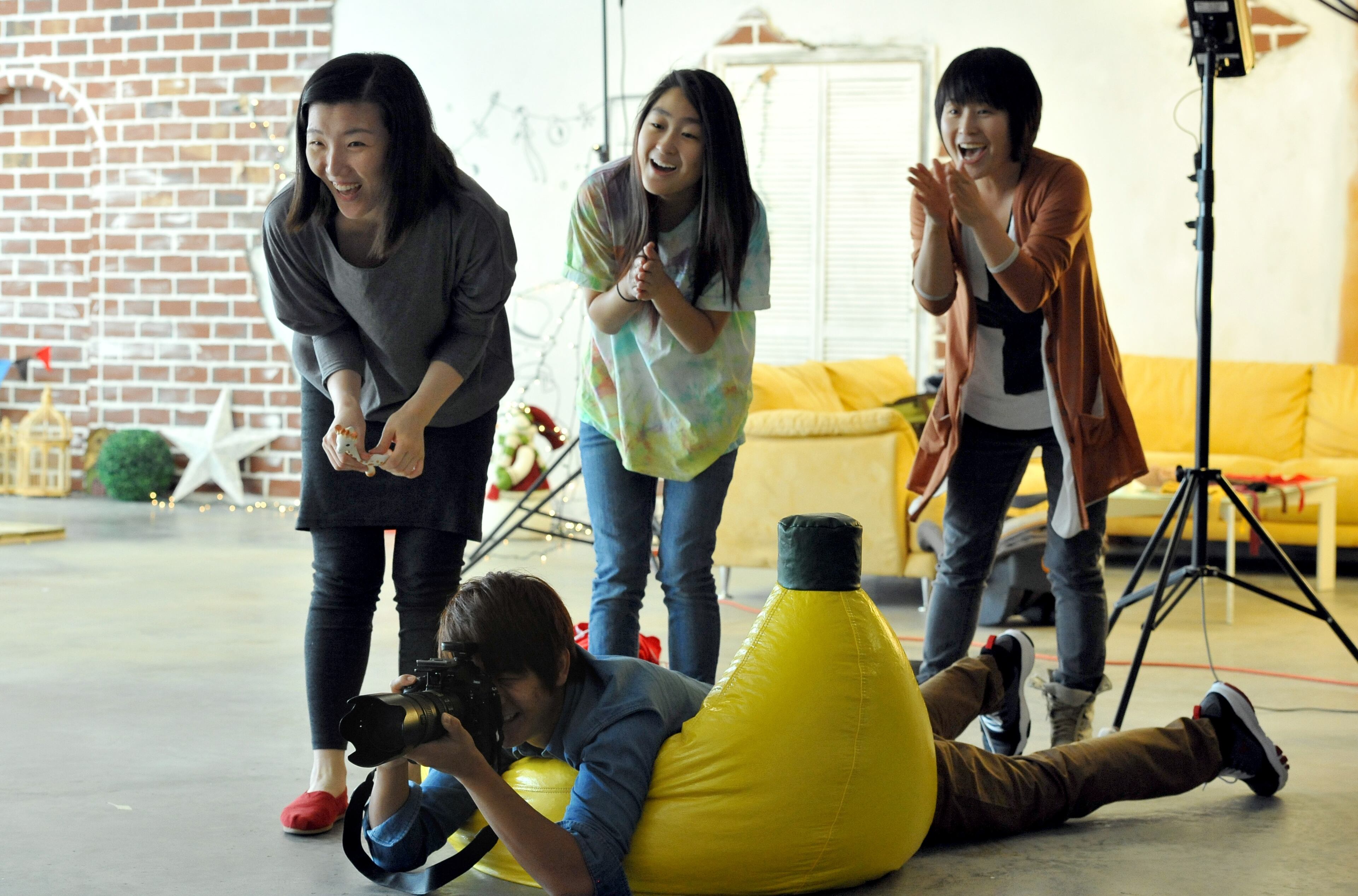 Ji Ae Song (left) of Duluth, assistant Seri Su and studio manager Mihyang Su entertain Song's 6-month-old daughter, Yeon Seo Pak, as photographer Garam Seo takes a picture at Shinhwa Photography Studio in Duluth.