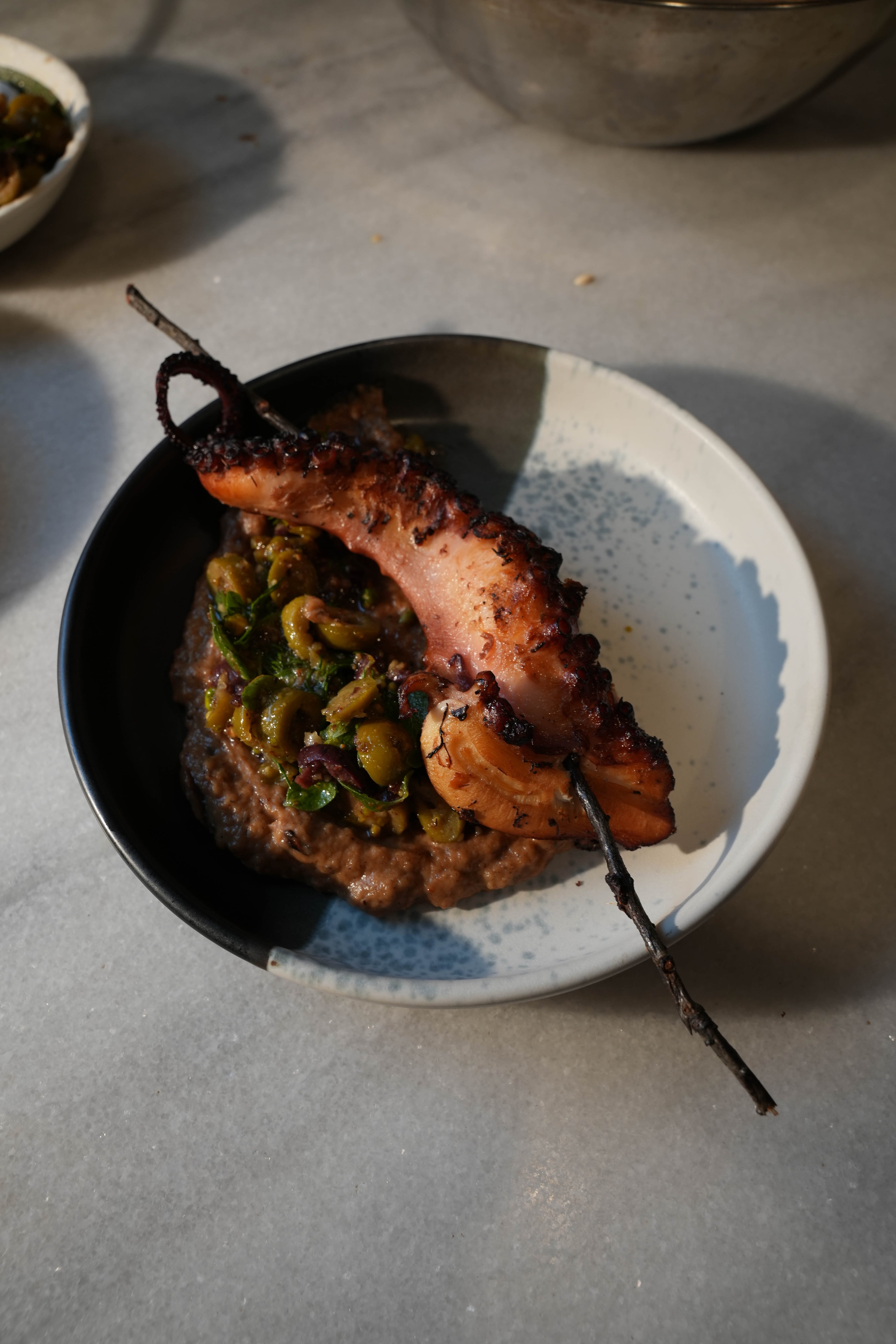 Gathered Grounds’ charcoal-grilled octopus with smoked eggplant puree and Greek tapenade. (Courtesy of Jamie Quiñones)