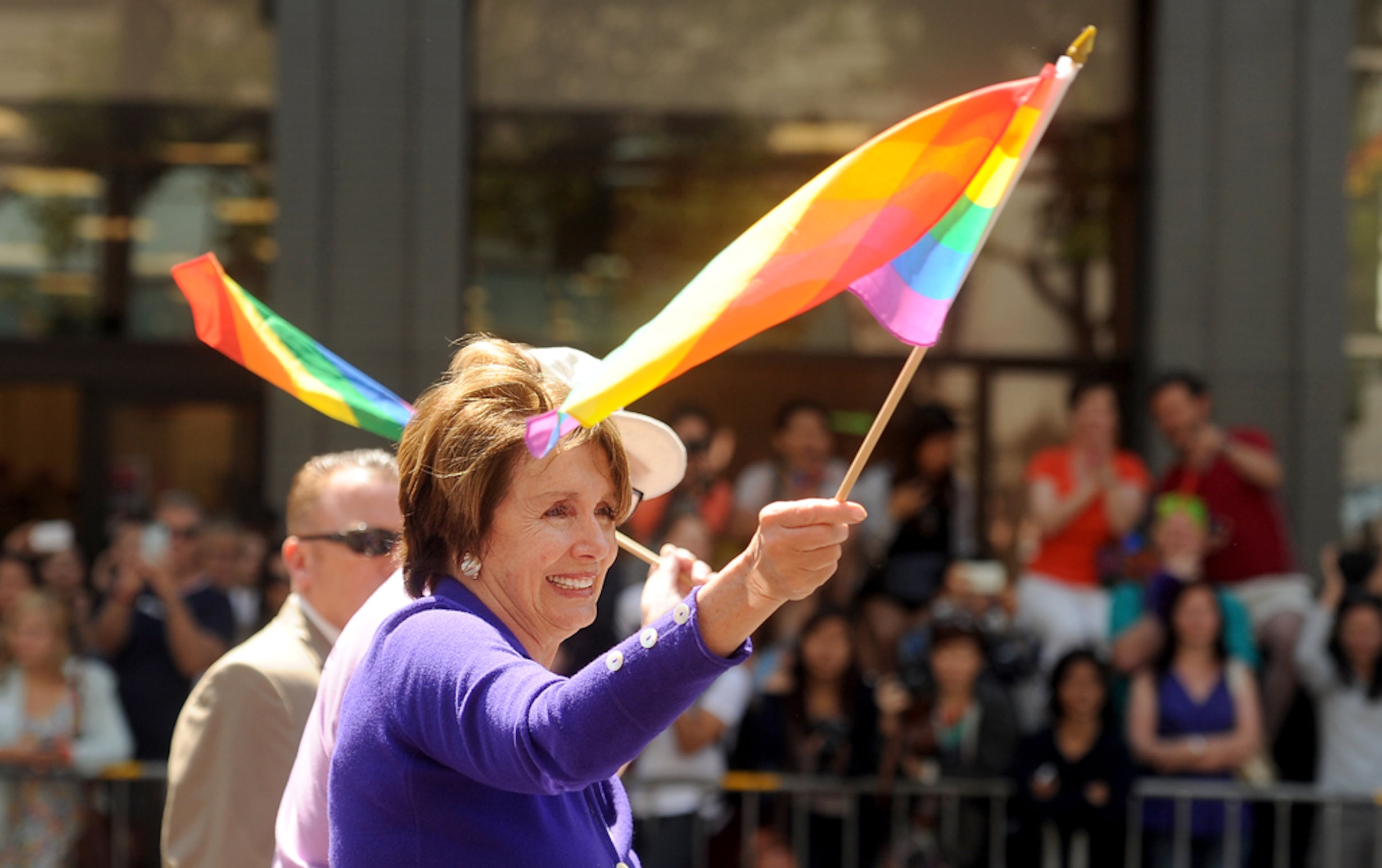 House Minority Leader Nancy Pelosi waves a rainbow flag while riding in San Francisco's 43rd annual gay pride parade Sunday, June 30, 2013. (AP Photo/Noah Berger)