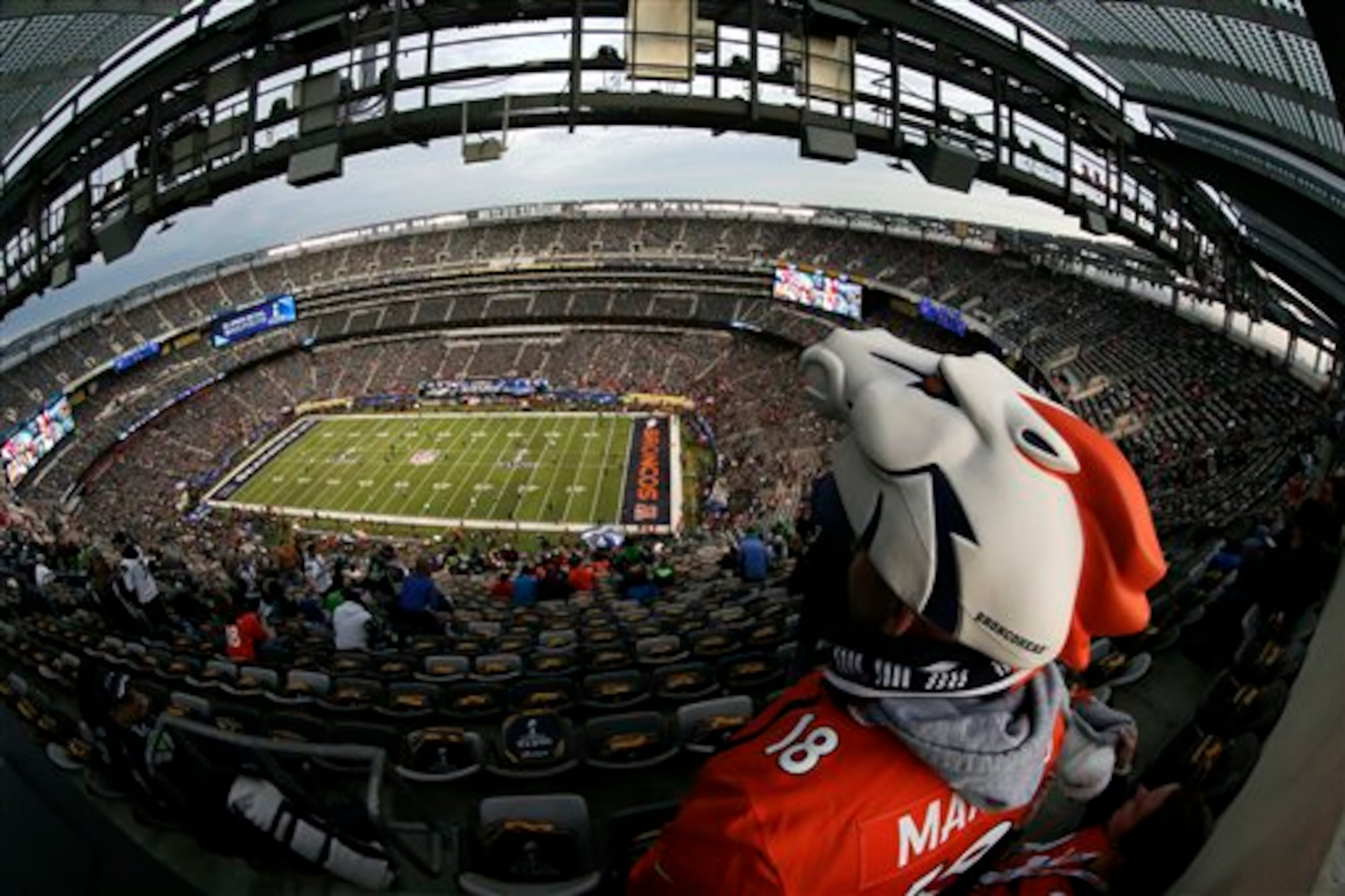 A Denver Broncos fan cheers before the NFL Super Bowl XLVIII football game against the Seattle Seahawks, Sunday, Feb. 2, 2014, in East Rutherford, N.J. (AP Photo/Charlie Riedel)