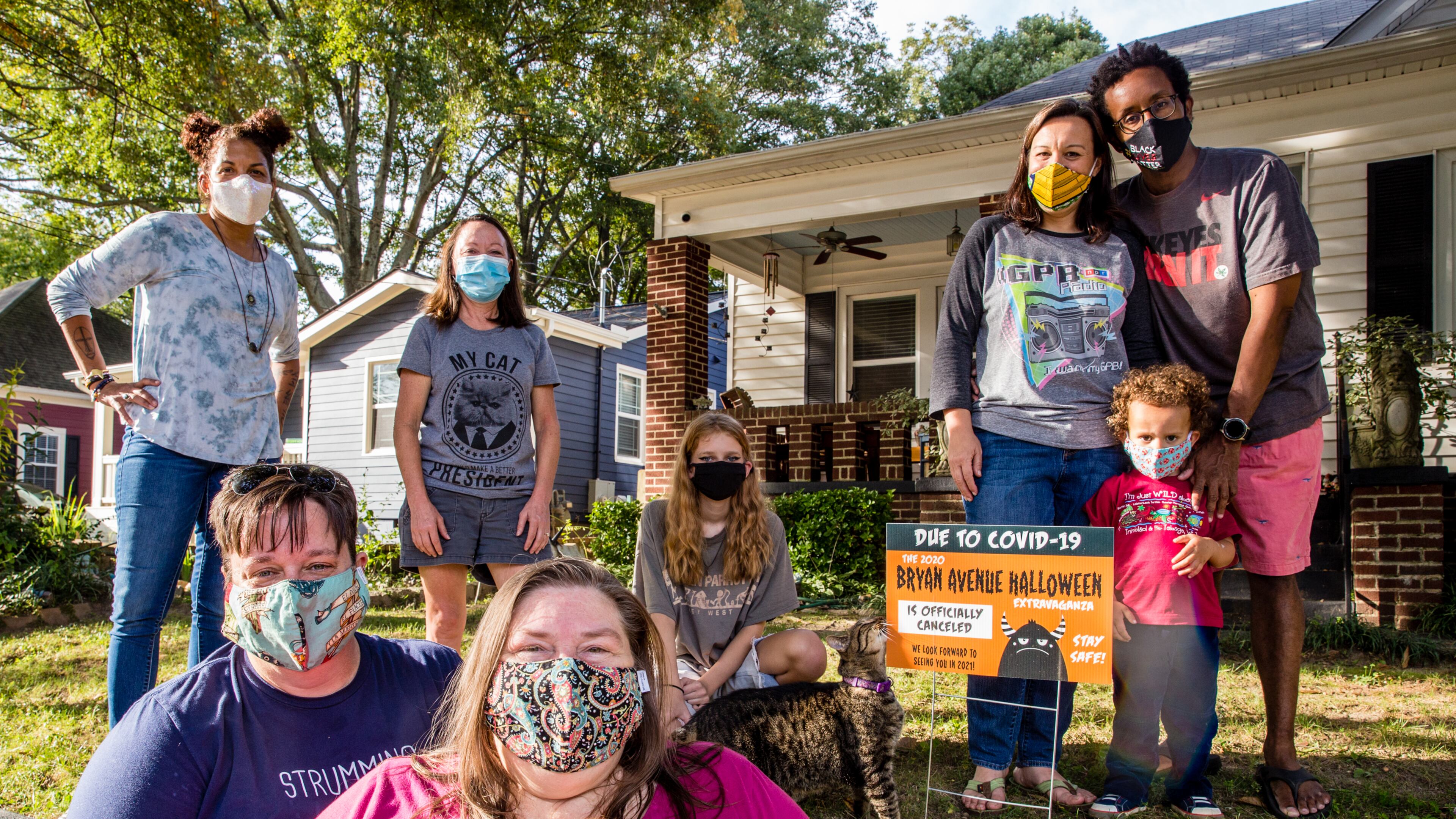 The East Point neighborhood around Bryan Avenue replaces Halloween decorations with yard signs announcing the 2020 extravaganza is canceled. The close-knit community includes Shannon Korta, from top left, Joann Richardson, Reagan Fizell; the Hackshaw family Emmalee, Kevin and 3-year-old Elliott; with Andria Towne, front left, and Sheila Merritt. Jenni Girtman for The AJC