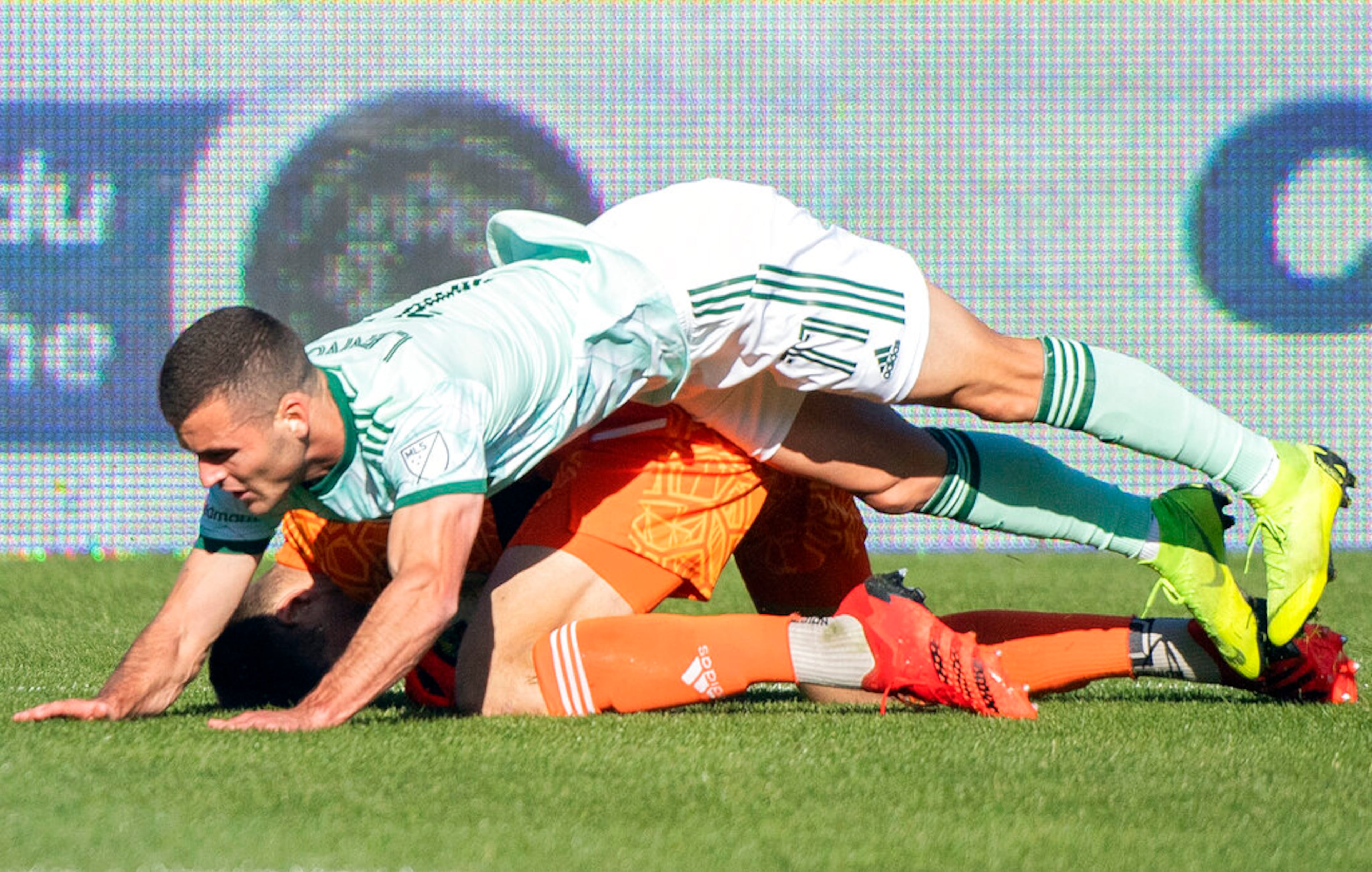 Atlanta United's Brooks Lennon (11) falls on top of CF Montreal's goalkeeper Sebastian Breza during the second half of an MLS soccer game in Montreal, Saturday, April 30, 2022. (Graham Hughes/The Canadian Press via AP)