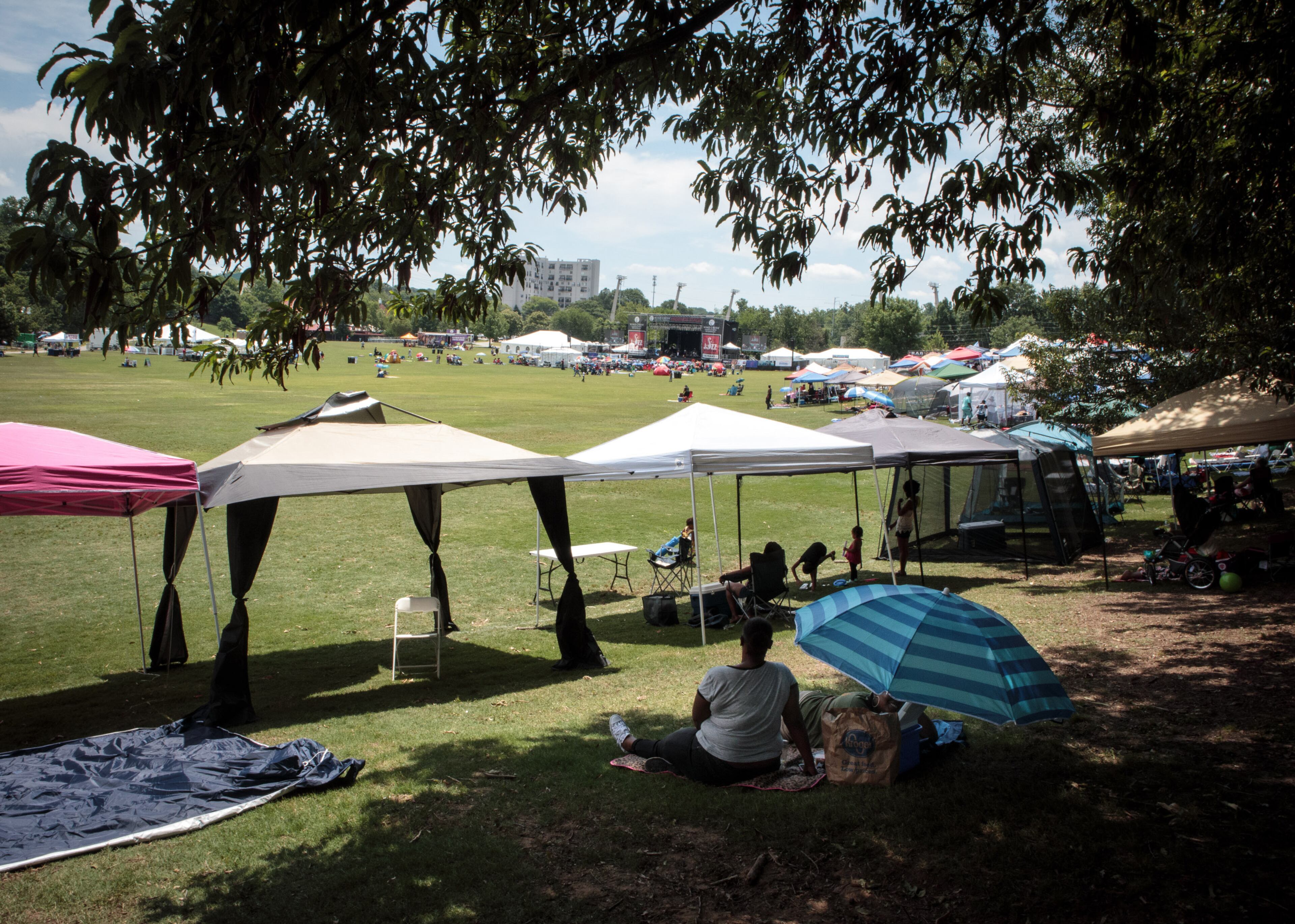 festivalgoers find shade under tents and umbrellas during the Atlanta Jazz Festival Saturday in Piedmont Park, May 27, 2017. This year marks the 40th anniversary of the Atlanta Jazz Festival and is expected to attract more than 100,000 attendees. STEVE SCHAEFER / SPECIAL TO THE AJC