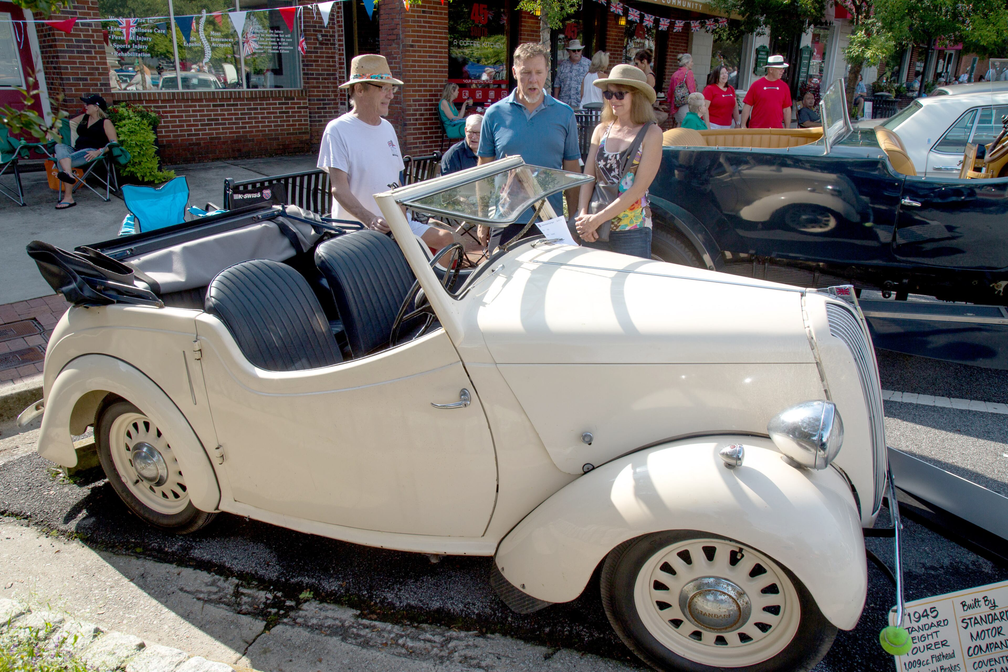 Steve Pritchett (center) and Melissa Farrar (right) talk with John Dunn, the owner of the 1945 Standard, during the 8th annual Atlanta British Car Fayre in downtown Norcross on Saturday, Sept. 8, 2018. (Photo: STEVE SCHAEFER / SPECIAL TO THE AJC)