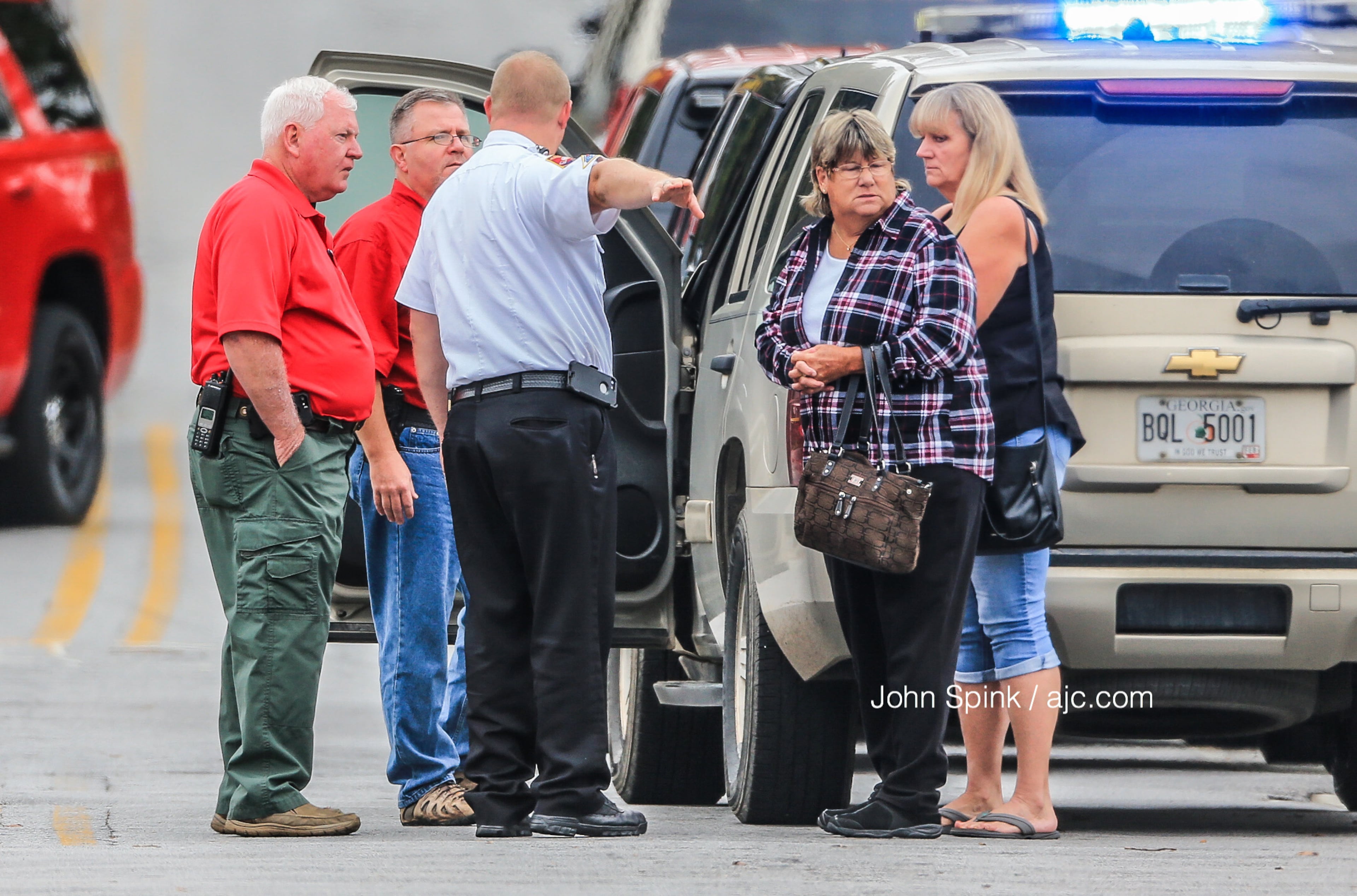 Authorities and others were on the scene of a shooting that left one man dead and sent two Forest Park police officers to hospitals. JOHN SPINK / JSPINK@AJC.COM