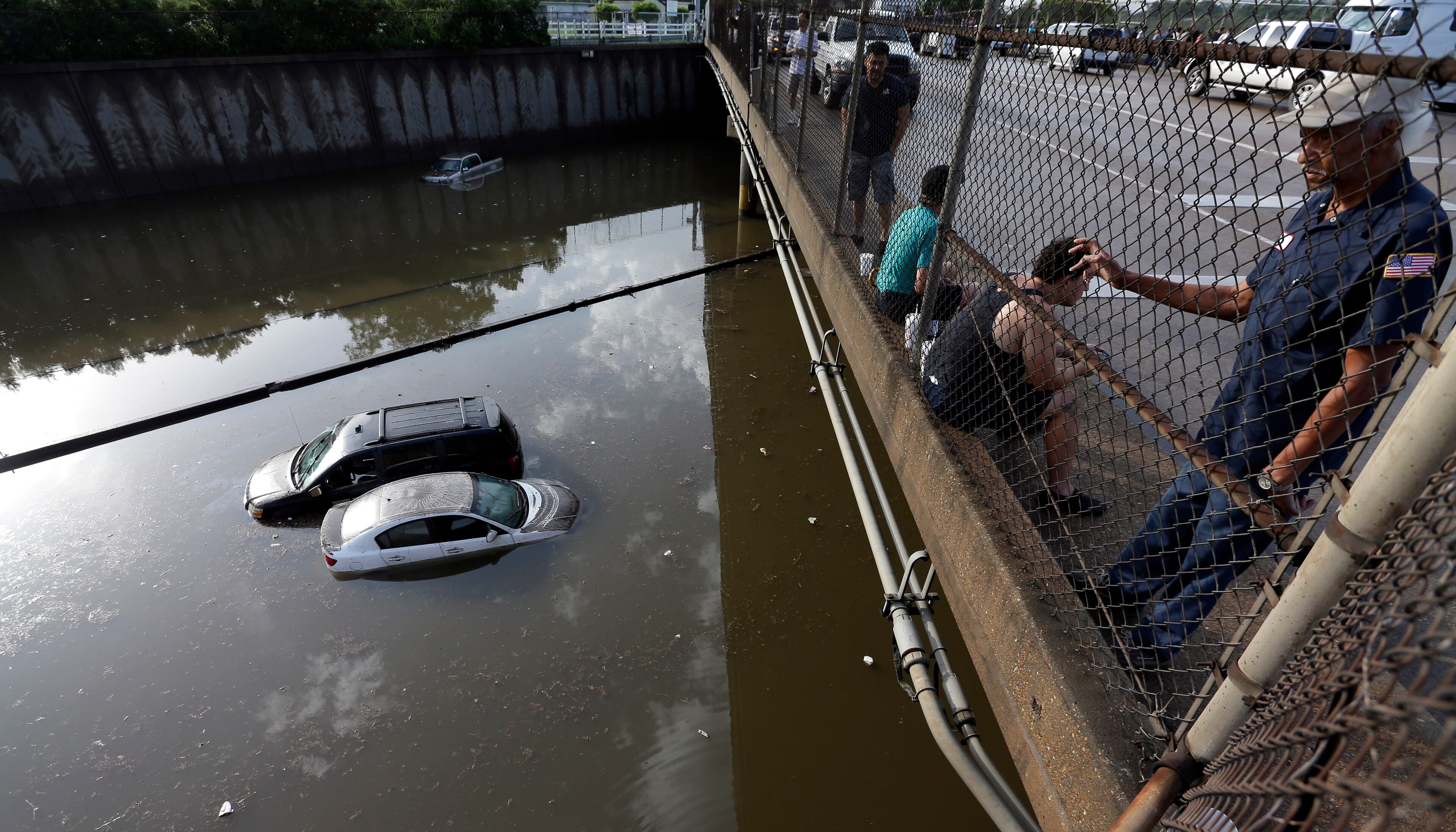 Cars sit in floodwaters along Interstate 45 after heavy overnight rain flooded parts of the highway in Houston, Tuesday, May 26, 2015. Several major highways in the Houston area are closed due to high water. (AP Photo/David J. Phillip)