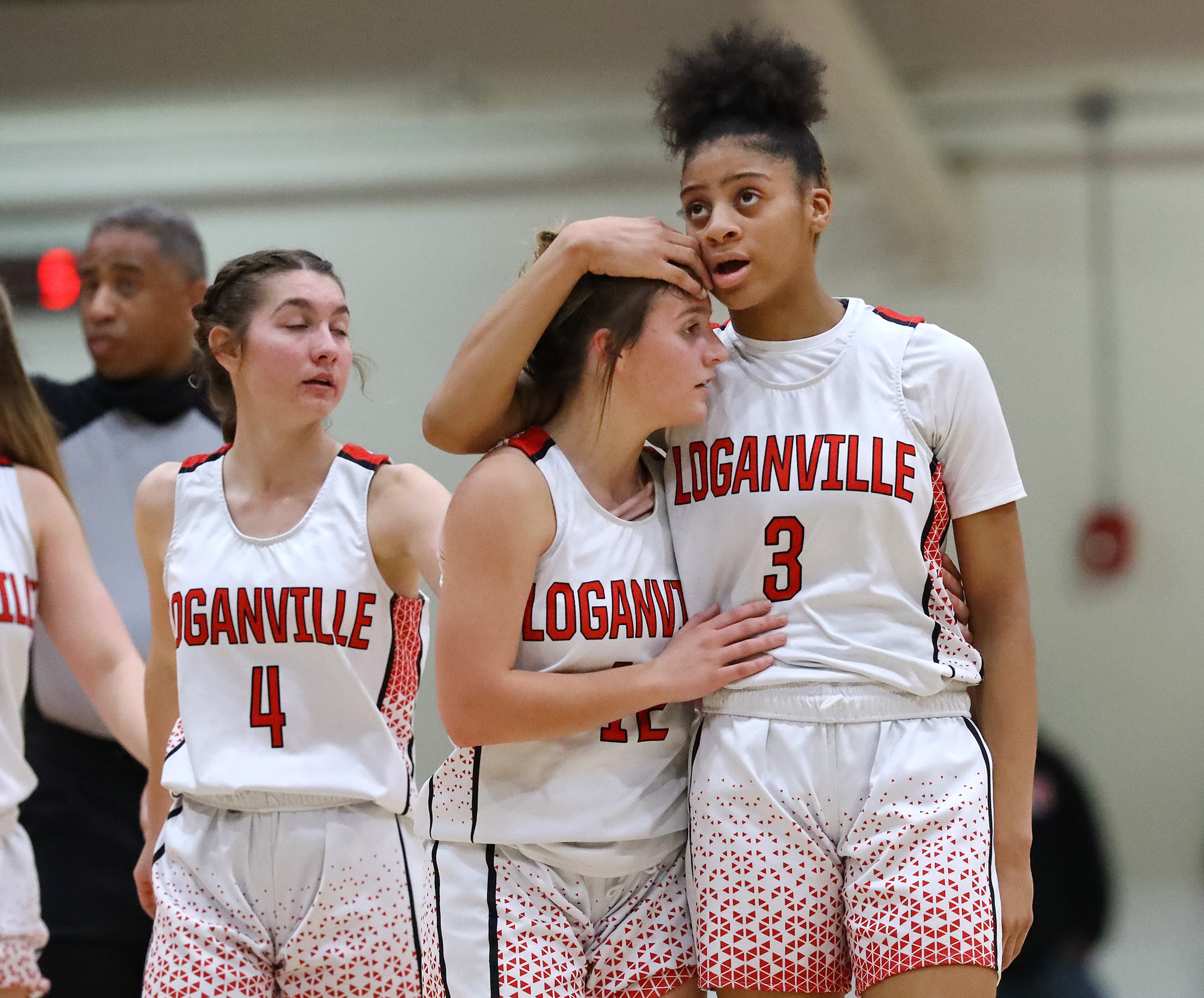 Loganville guard Sydney Bolden (right) consoles teammate Caty Beth Bolemon as she fouls out of the game during the final minutes of a 40-52 loss to Forest Park in their high school basketball tournament game on Wednesday, March 2, 2022, in Loganville. “Curtis Compton / Curtis.Compton@ajc.com”`