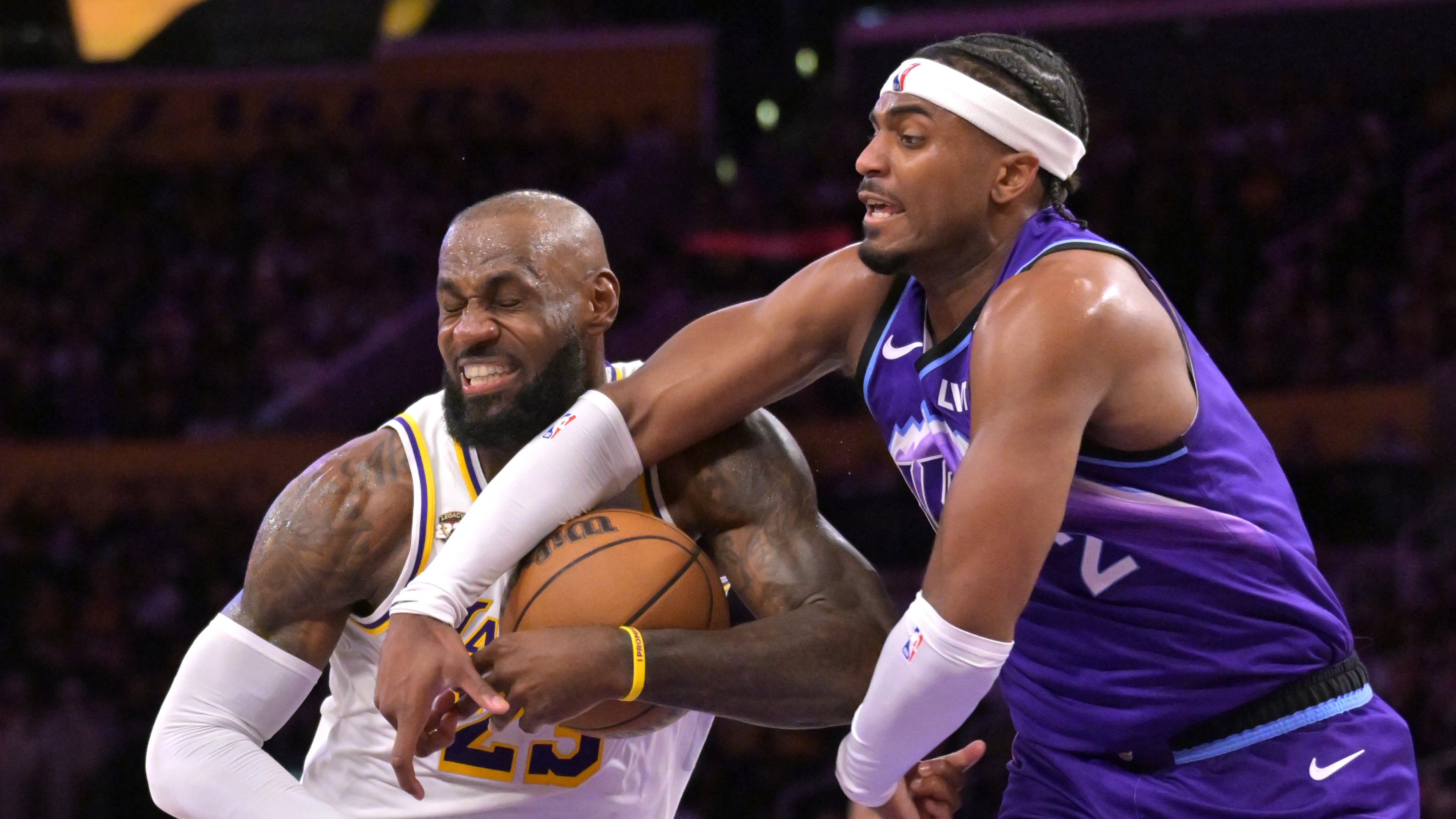 Los Angeles Lakers forward LeBron James, left, is fouled by Utah Jazz forward Blake Hinson (2) as he drives to the basket during the first half of an NBA basketball game Sunday, April 12, 2026, in Los Angeles. (AP Photo/Jayne Kamin-Oncea)