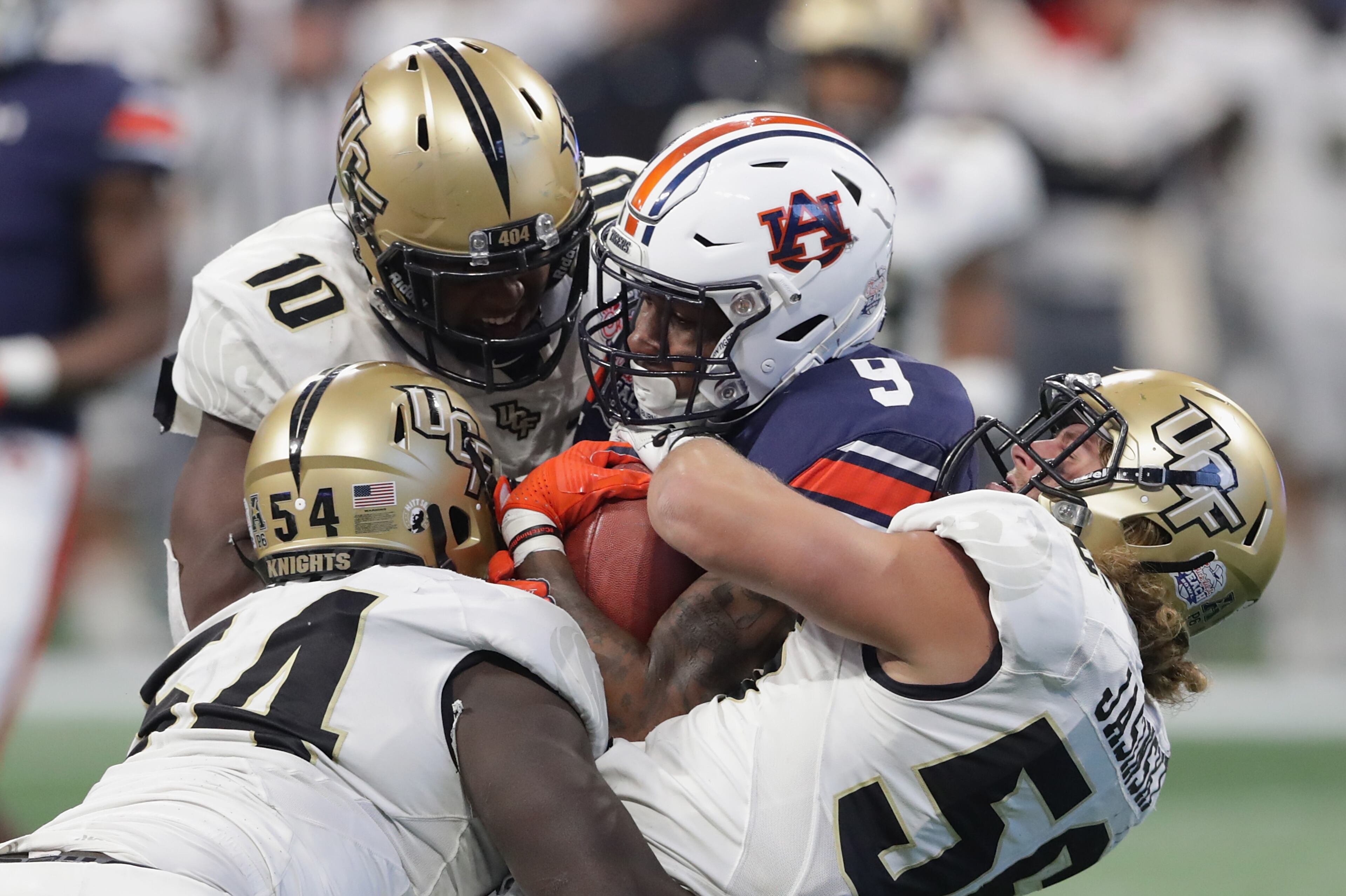 ATLANTA, GA - JANUARY 01: Kam Martin #9 of the Auburn Tigers is tackled by the UCF Knights in the second half during the Chick-fil-A Peach Bowl at Mercedes-Benz Stadium on January 1, 2018 in Atlanta, Georgia. (Photo by Streeter Lecka/Getty Images)