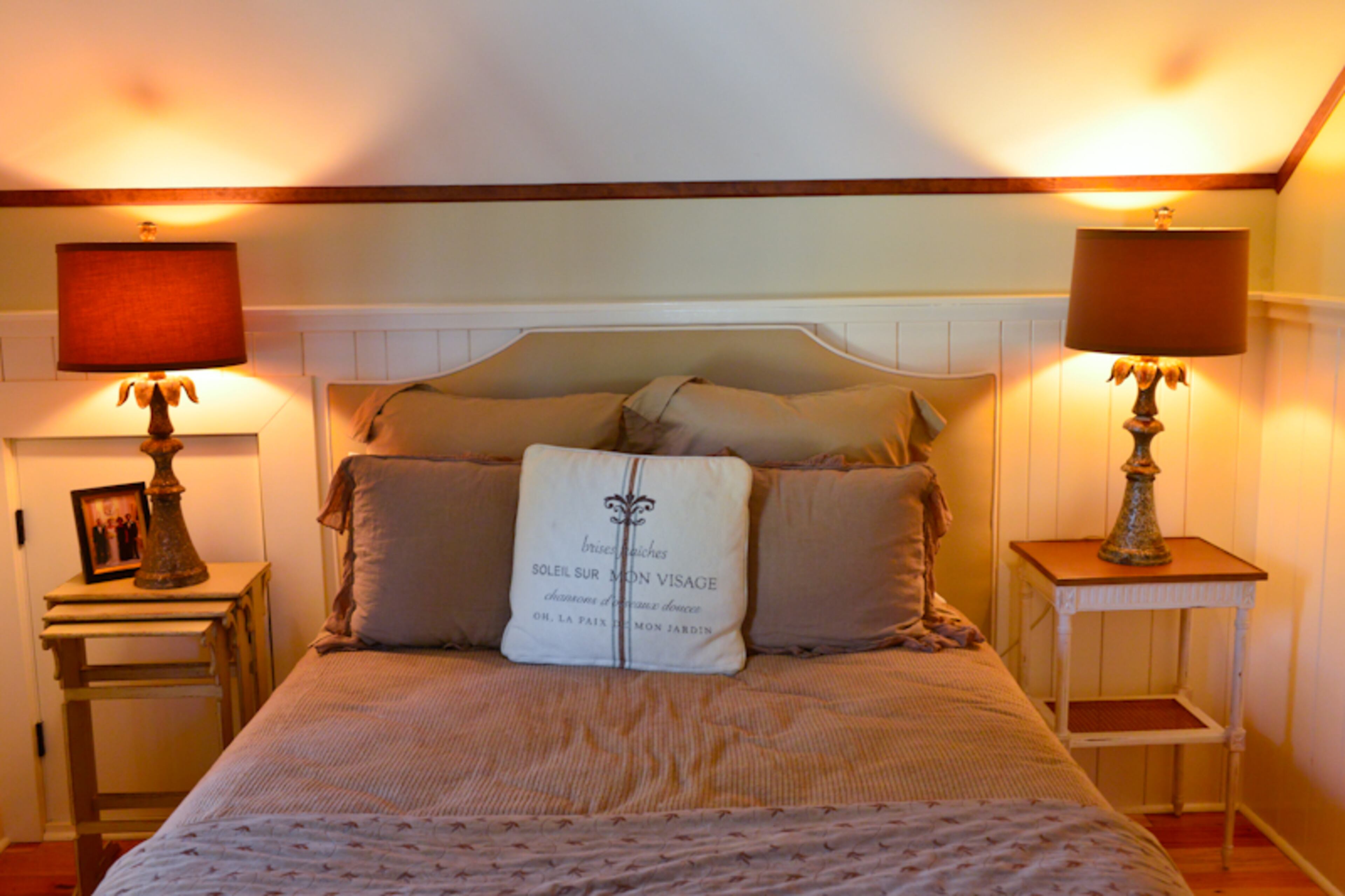 In the upstairs guest room above the garage addition, linens from Bella Notte create a cozy retreat to welcome visitors to Patrick and Erin Connolly's Buckhead home.