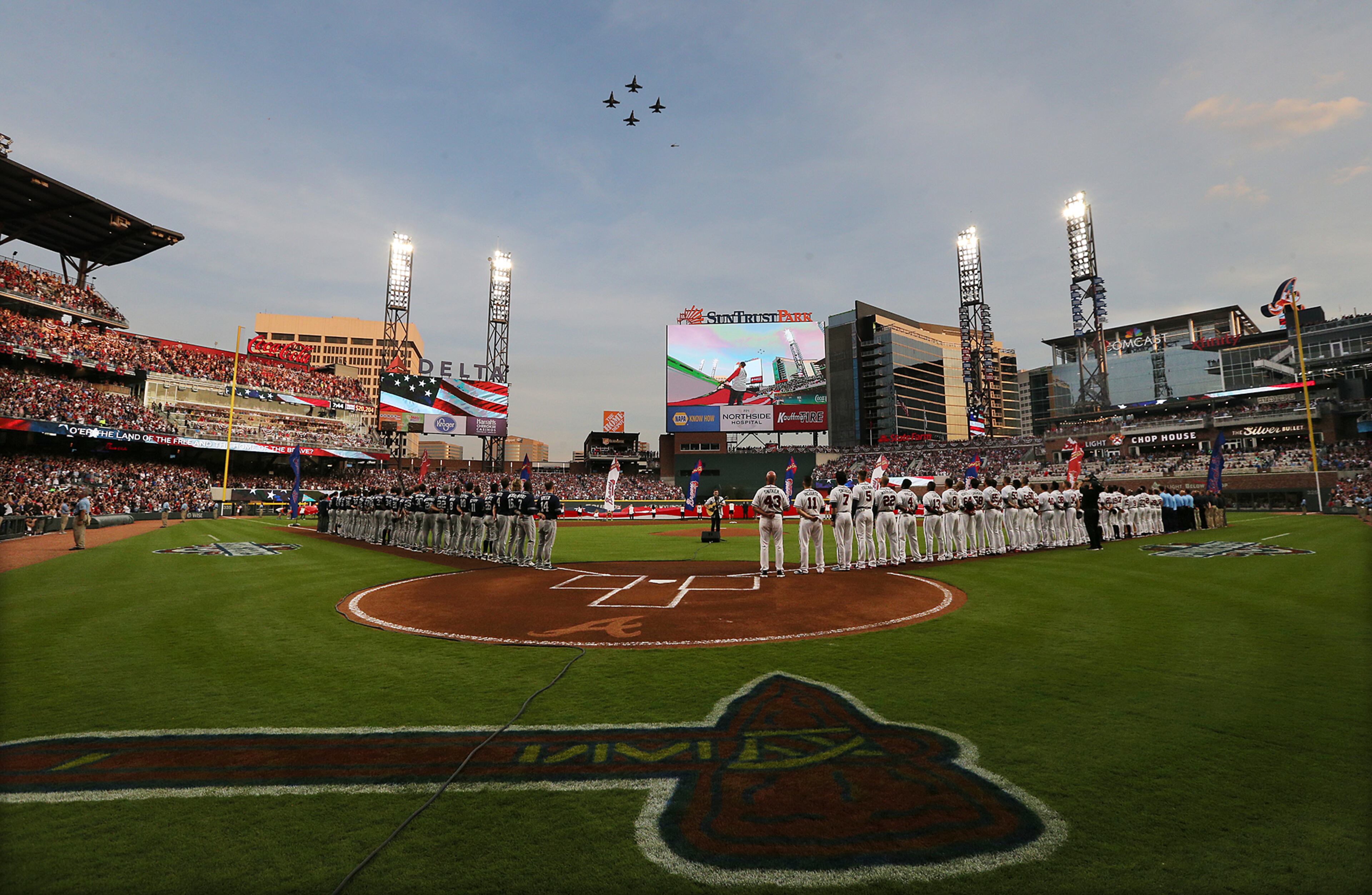 Fighter planes fly over during the National Anthem for the Braves home opener against the Padres at SunTrust Park on Friday, April 14, 2017.