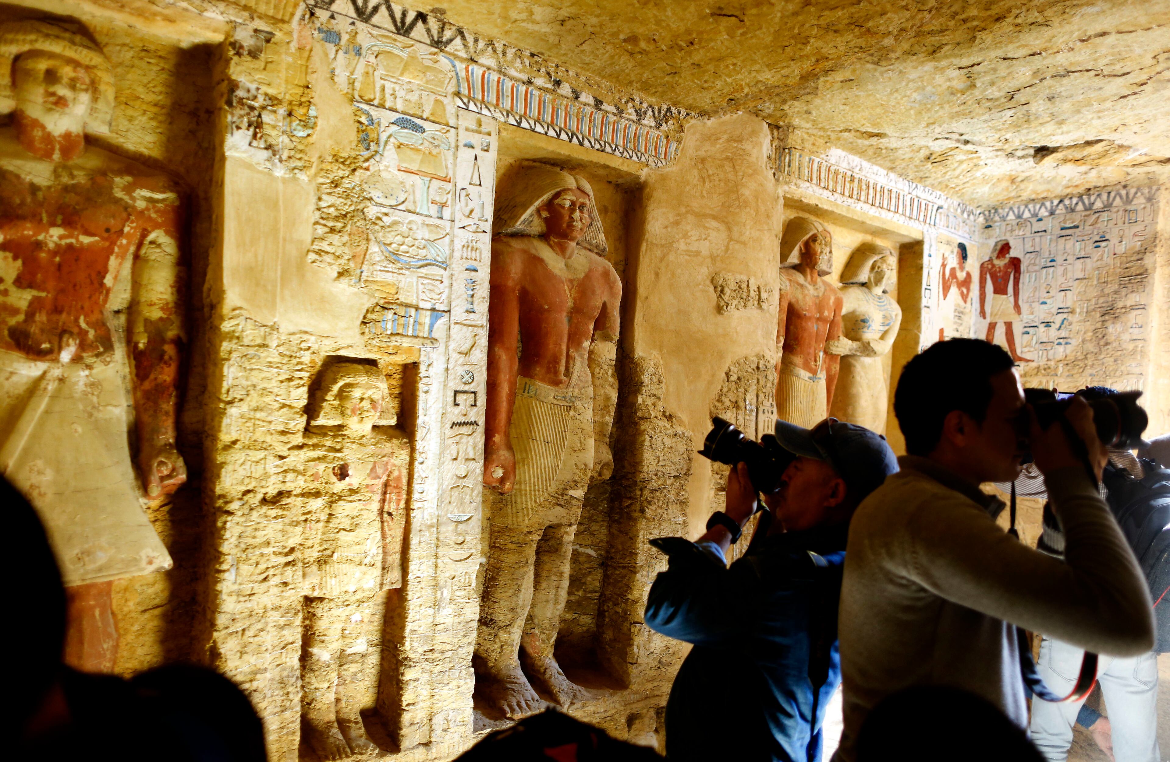Photographers film inside the recently uncovered tomb of the Priest royal Purification during the reign of King Nefer Ir-Ka-Re, named "Wahtye", at the site of the step pyramid of Saqqara, in Giza, Egypt, Saturday, Dec. 15, 2018. The Egyptian Archaeological Mission working at the Sacred Animal Necropolis in Saqqara archaeological site succeeded to uncover the tomb, Antiquities Minister Khaled el-Anani, announced.(AP Photo/Amr Nabil)