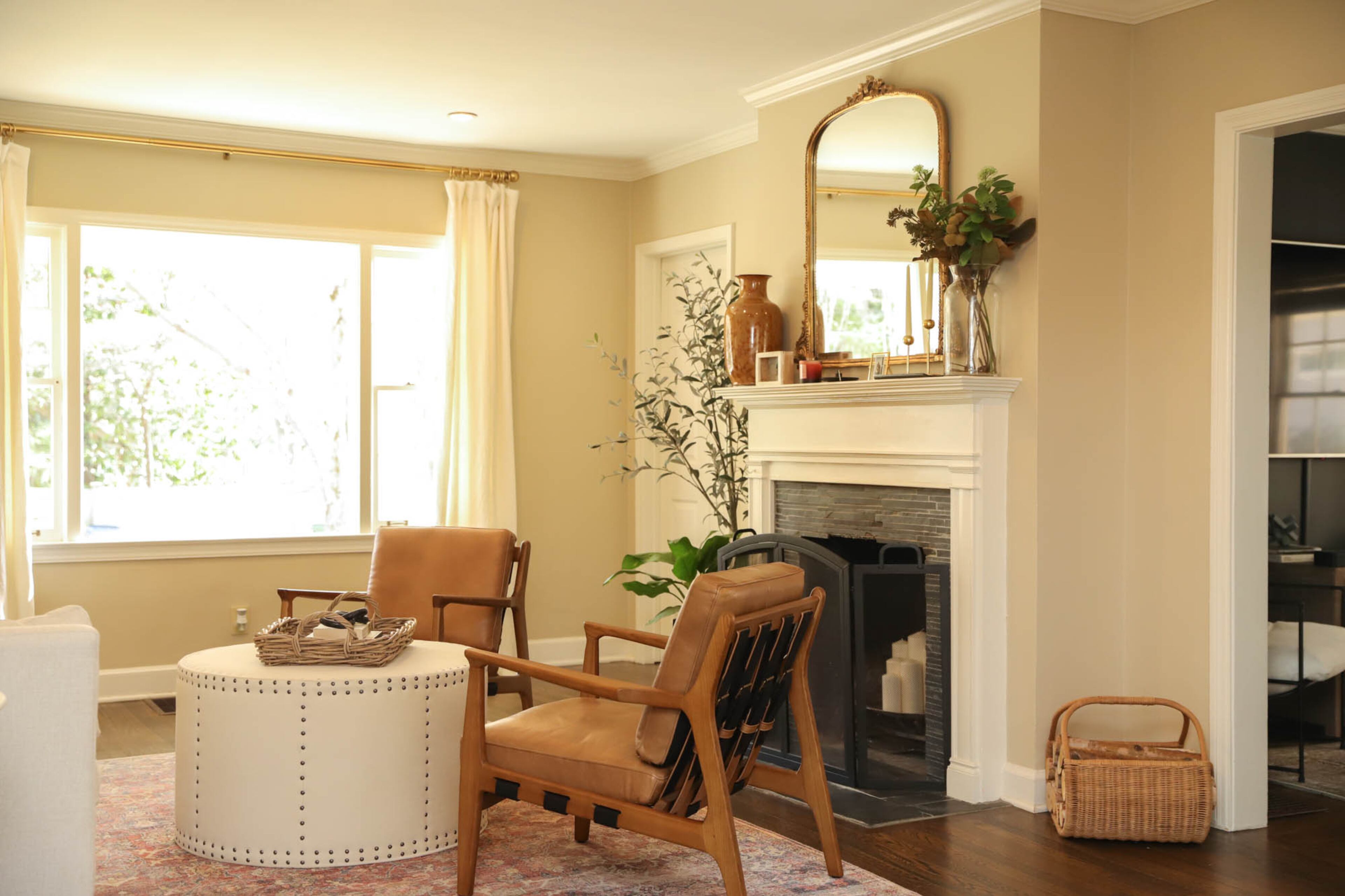 “When you walk into the house, this living space is the first room you see, which I love because of the way it’s decorated,” Kerry Phillips says. It’s accentuated with warm leather accents, like the circular ottoman from Lee Industries and the cushy armchairs from Four Hands that Phillips appreciates for the strappy leather details at the back. Text by Lori Keong/Photo by Reynolds Rogers