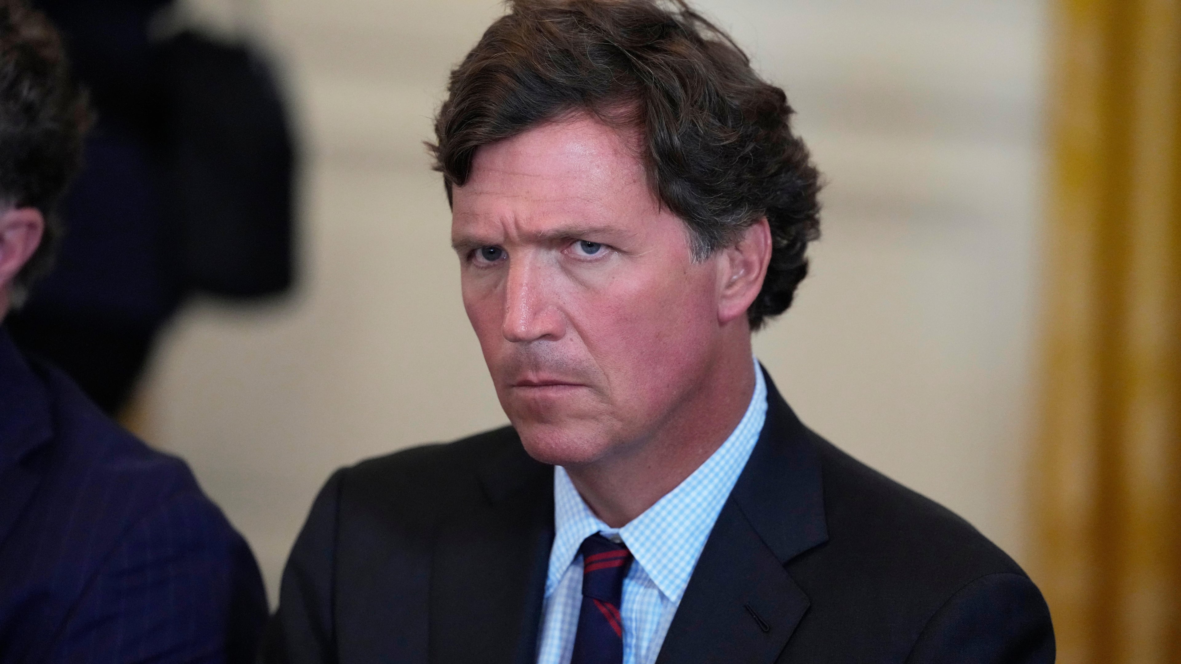 FILE - Tucker Carlson attends a meeting with President Donald Trump and oil executives in the East Room of the White House, Jan. 9, 2026, in Washington. (AP Photo/Alex Brandon, File)