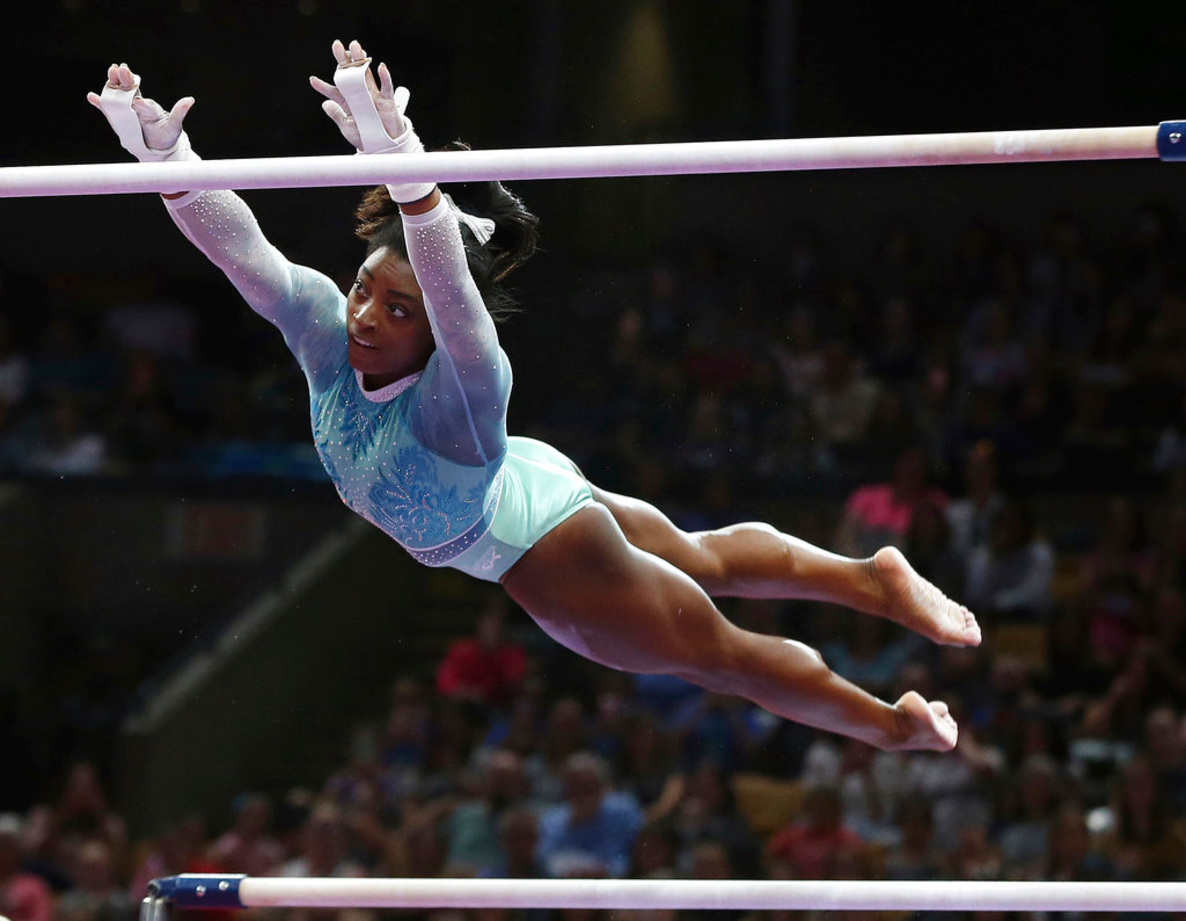 Simone Biles competes on the uneven bars at the U.S. Gymnastics Championships, Sunday, Aug. 19, 2018, in Boston. (AP Photo/Elise Amendola)