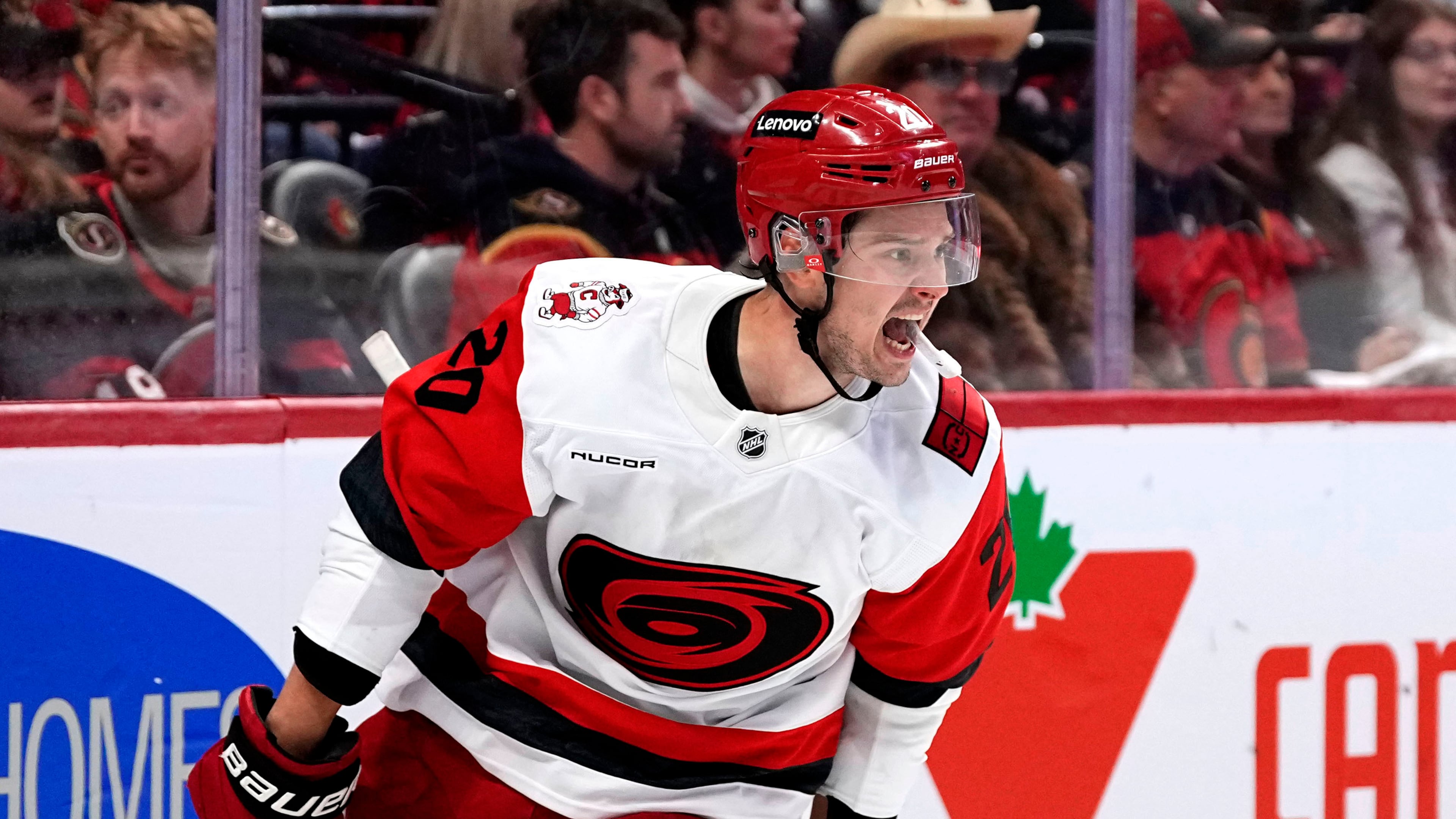 Carolina Hurricanes' Sebastian Aho (20) celebrates scoring an empty net goal against the Ottawa Senators in the third period in Game 4 of a first-round NHL Stanley Cup playoff hockey series, Saturday, April 25, 2026, in Ottawa, Ontario. (Justin Tang/The Canadian Press via AP)