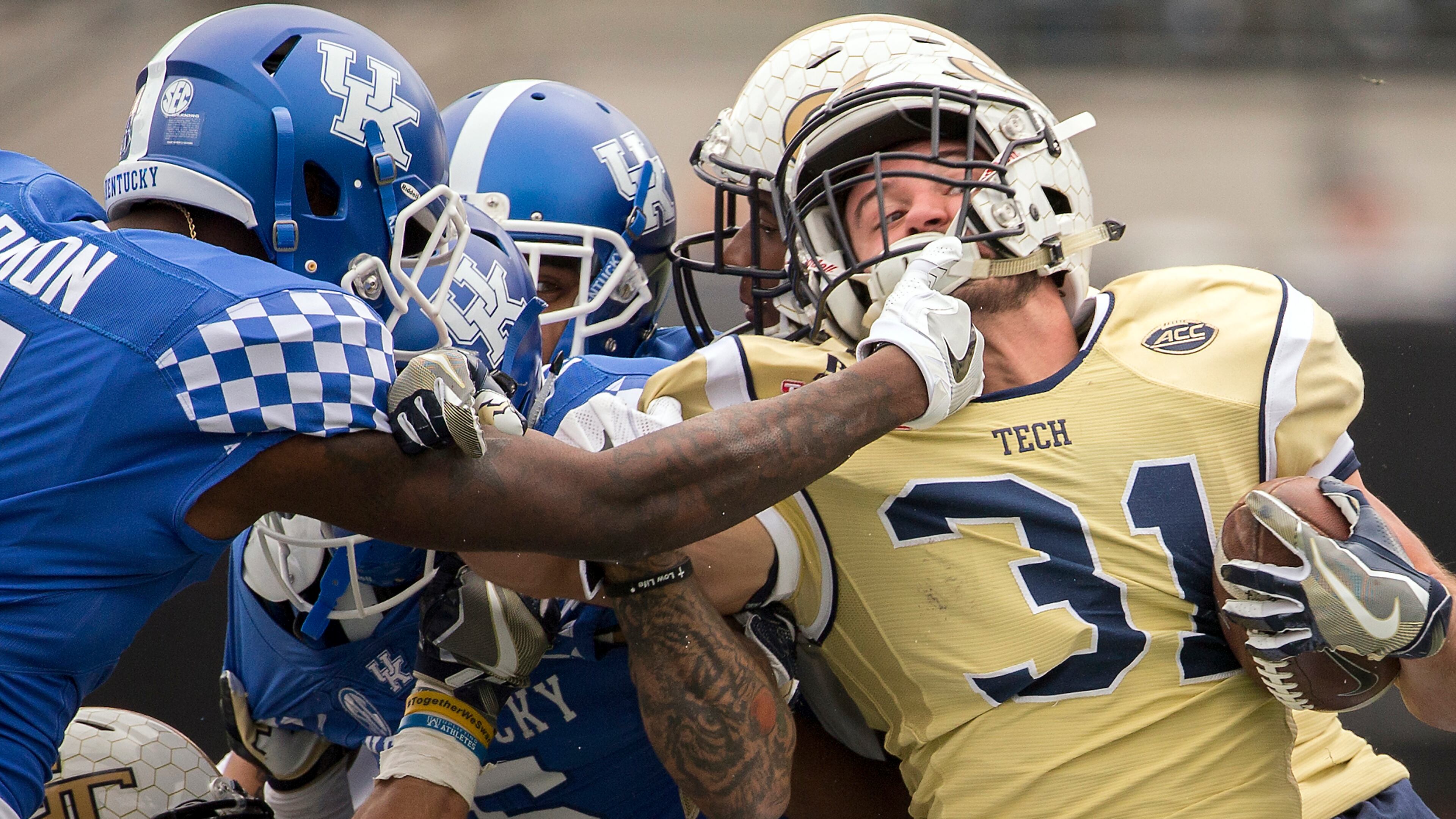 Georgia Tech running back Nate Cottrell, right, is tackled by Kentucky cornerback J.D. Harmon (11) on a kick return during the second half of the TaxSlayer Bowl NCAA college football game, Saturday, Dec. 31, 2016, in Jacksonville, Fla. Georgia Tech beat Kentucky 33-18. (AP Photo/Stephen B. Morton)