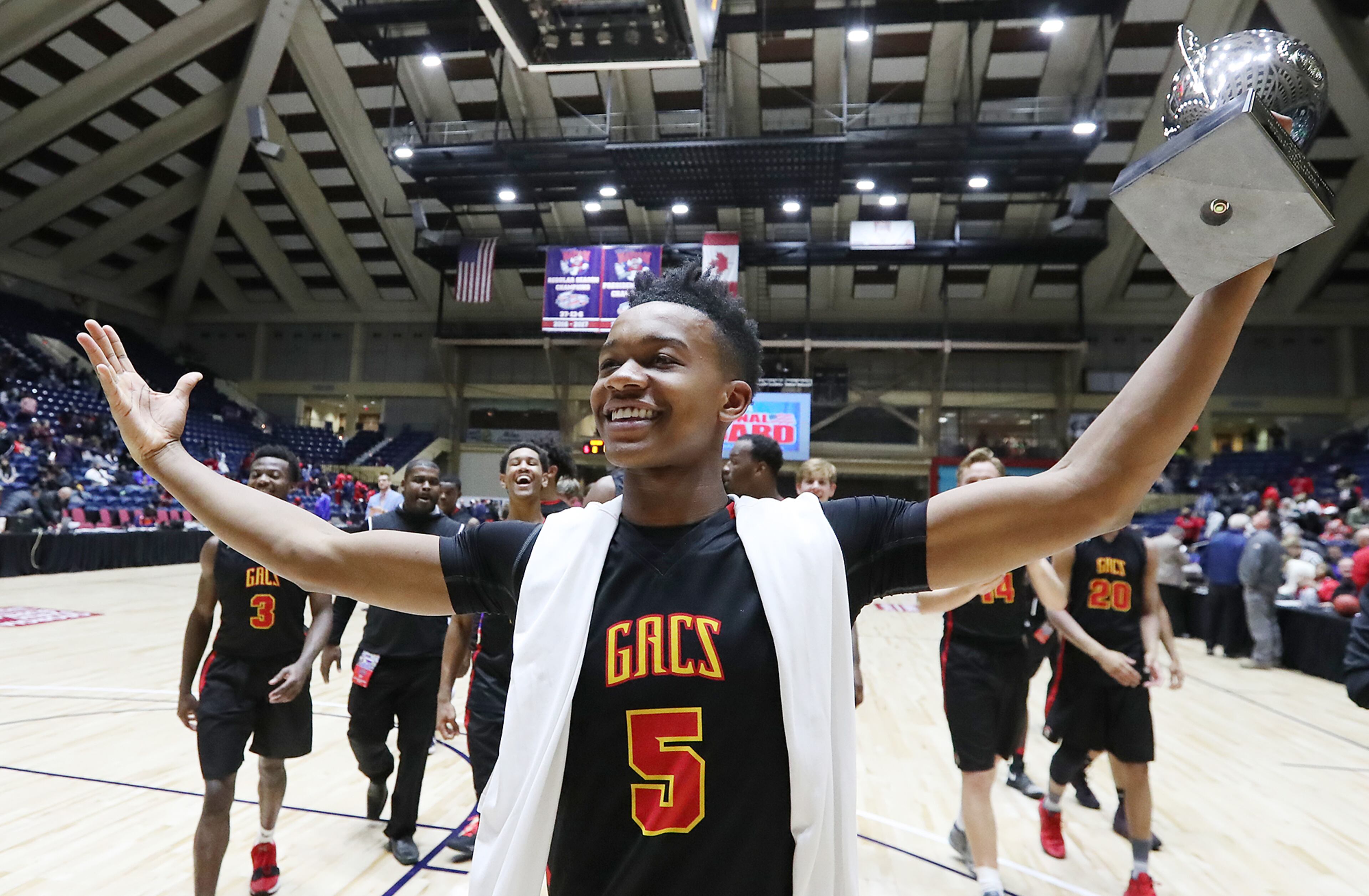 March 8, 2018 Macon: GAC guard Jared Hamilton hoists the trophy celebrating beating Jenkins 67-53 in their GHSA state basketball championship game on Thursday, March 8, 2018, in Macon. Curtis Compton/ccompton@ajc.com