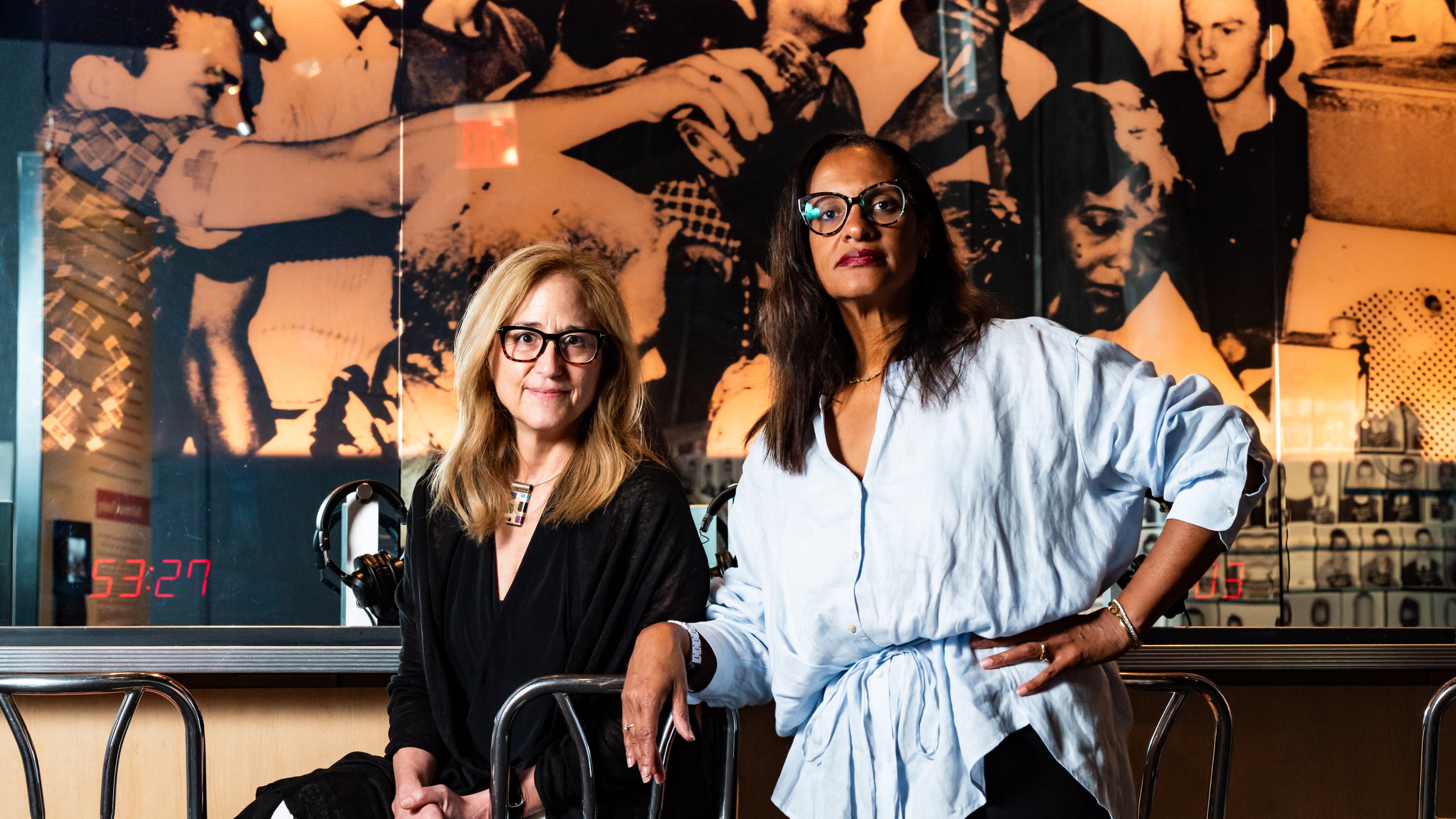 CEO Jill Savitt, left, and Chief Program Officer Kama Pierce of the National Center for Civil and Human Rights, pose at an exhibit designed to immerse visitors in a civil rights era lunch counter sit-in protest in Atlanta on Thursday, July 11, 2024. (Seeger Gray / AJC)