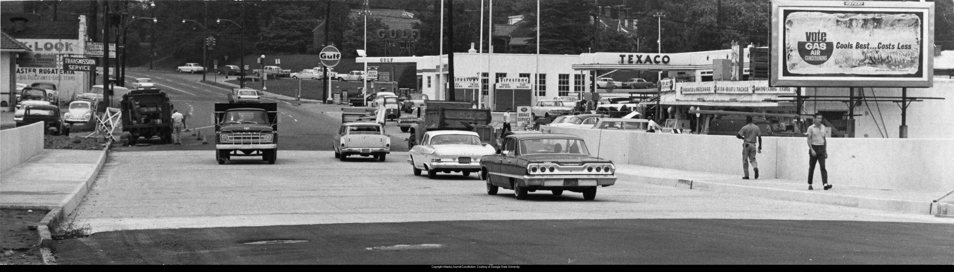 New bridge on Piedmont Avenue, Atlanta, Georgia, July 1964. Photo: Billy Downs. Original caption: "Piedmont 'Funnel' widened. A joyous sight for Piedmont Avenue motorists is this new bridge near the intersection of Piedmont and Monroe Drive, NE. Note there is traffic traveling over the new bridge. The new bridge is at least twice as wide as the old one. The temporary traffic bridge, not pictured, but to the left, could handle only two lanes of traffic. The new bridge speeds Piedmont traffic. Those traveling this section may get home earlier in the future."