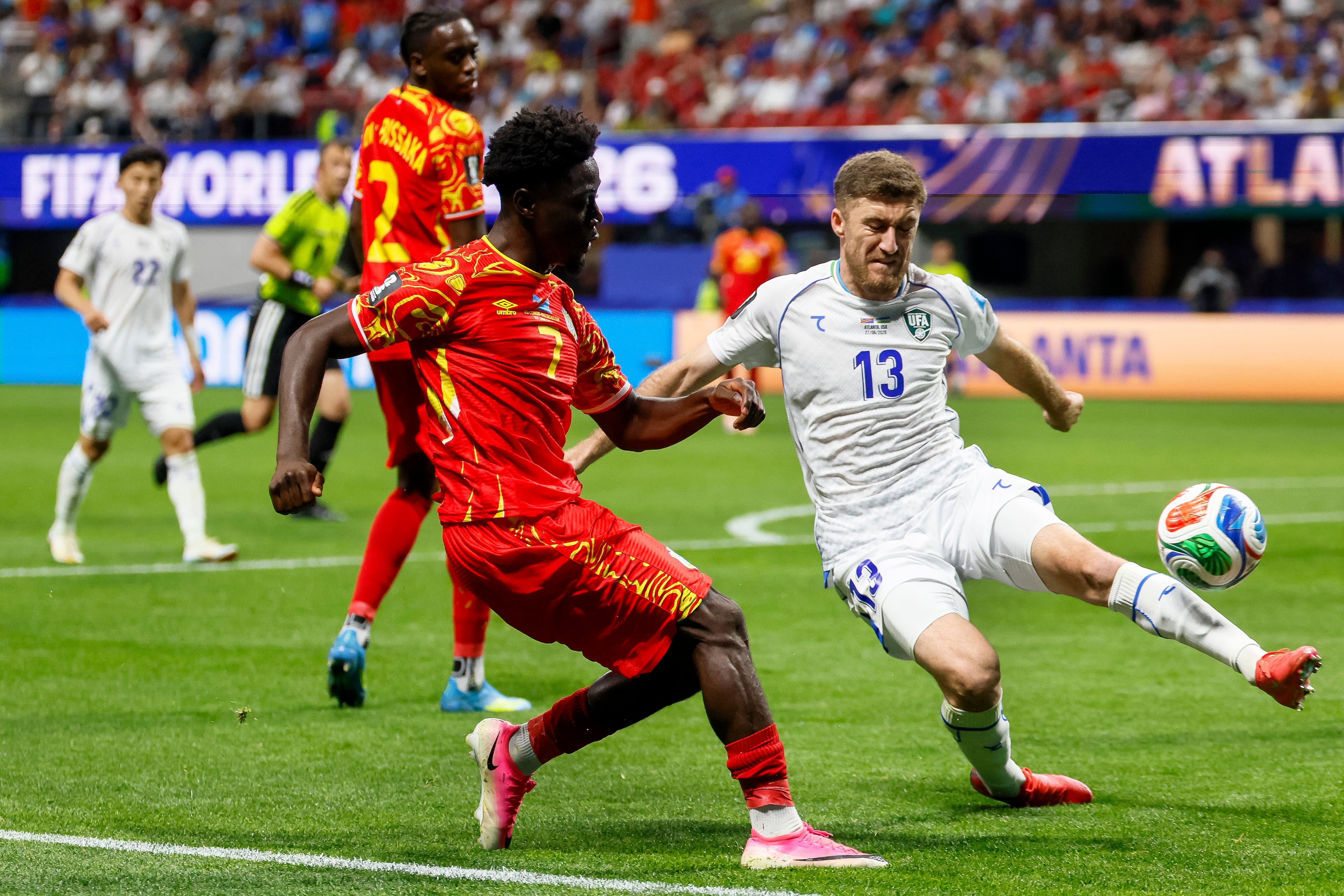 Uzbekistan defender Sherzod Nasrullaev (right) tries to steal the ball from Congo forward Nathanaël Mbuku during the first half of a FIFA World Cup match at Atlanta Stadium (Mercedes-Benz Stadium) on Saturday, June 27, 2026, in Atlanta. (Miguel Martinez/AJC)