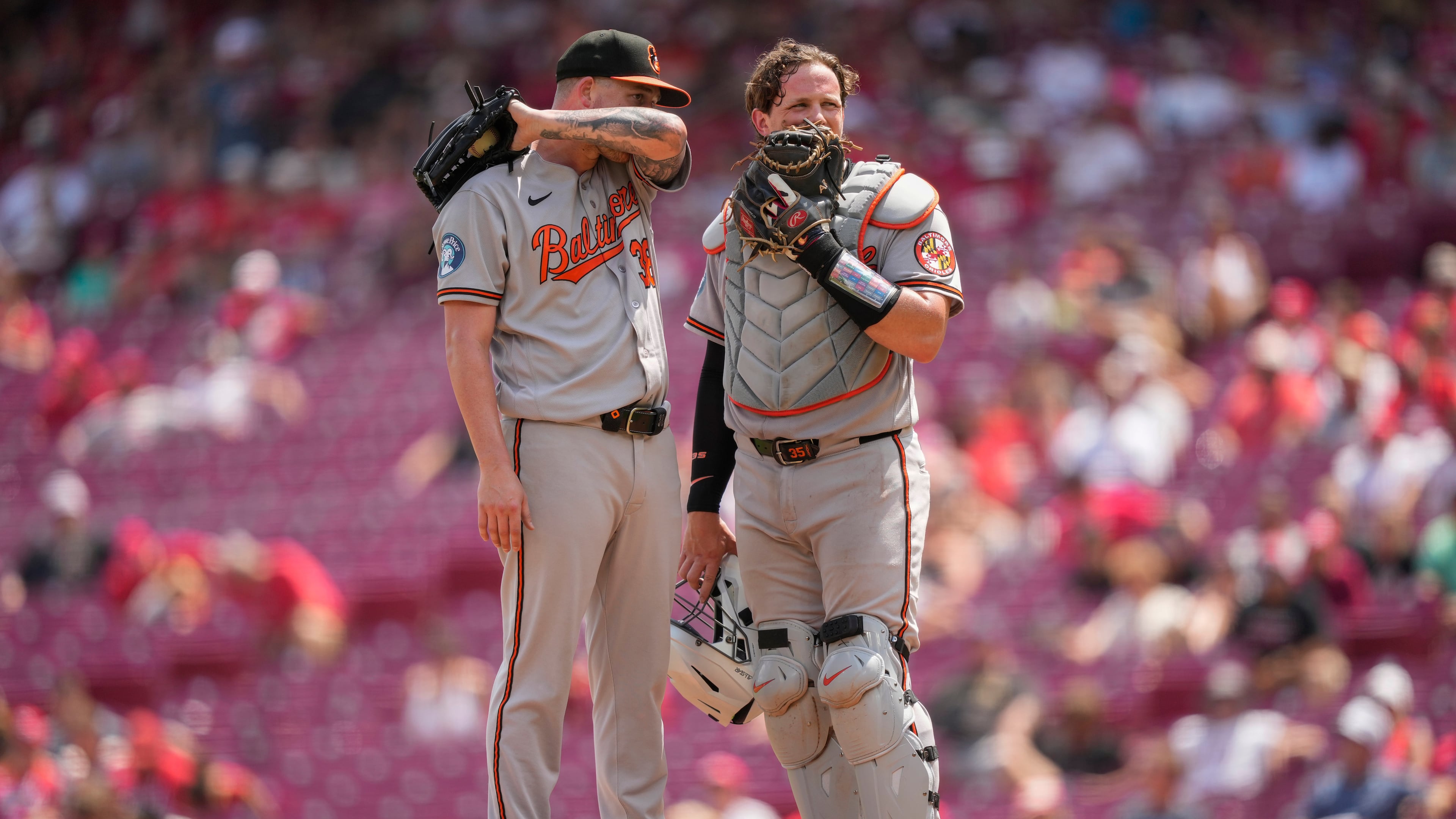 Baltimore Orioles pitcher Kyle Bradish, left, and catcher Adley Rutschman, right, talk on the mound during the eighth inning of a baseball game against the Cincinnati Reds in Cincinnati, Sunday, July 5, 2026. (AP Photo/Carolyn Kaster)