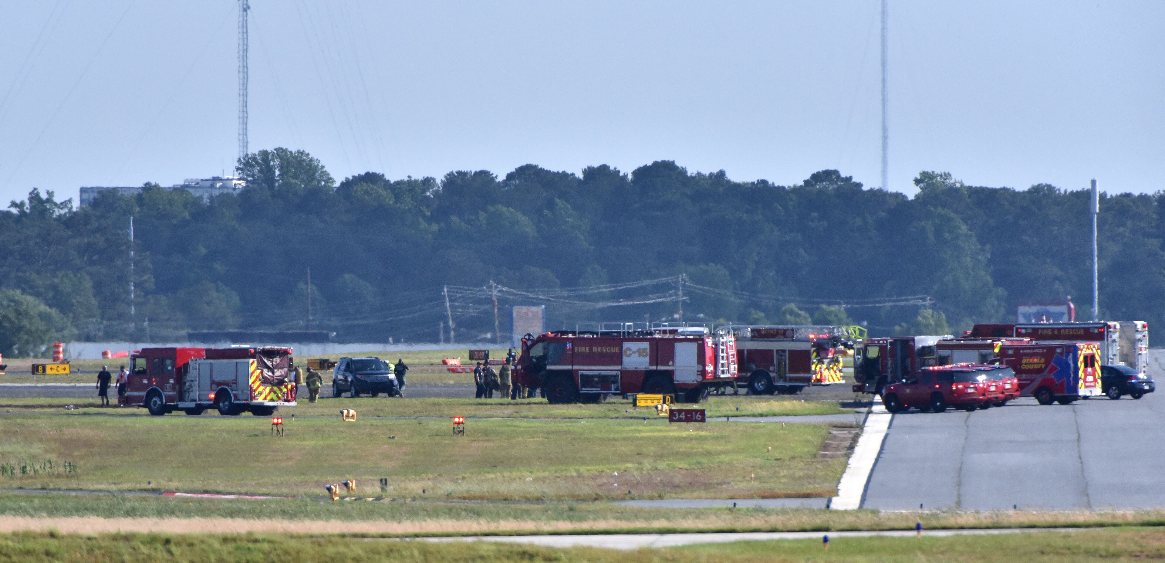 Authorities investigate the crash scene at the Peachtree-DeKalb Airport on Saturday afternoon, May 14, 2016. The pilot of a plane was killed Saturday afternoon when it crashed during an air show at Peachtree-DeKalb Airport, officials said. The crash occurred near the end of the Good Neighbor Day Air Show and Open House at PDK, about 4:49 p.m. The pilot was from the Augusta area, airport director Mario Evans said Saturday at a media briefing. His identity was not released, pending notification of next of kin. HYOSUB SHIN / HSHIN@AJC.COM