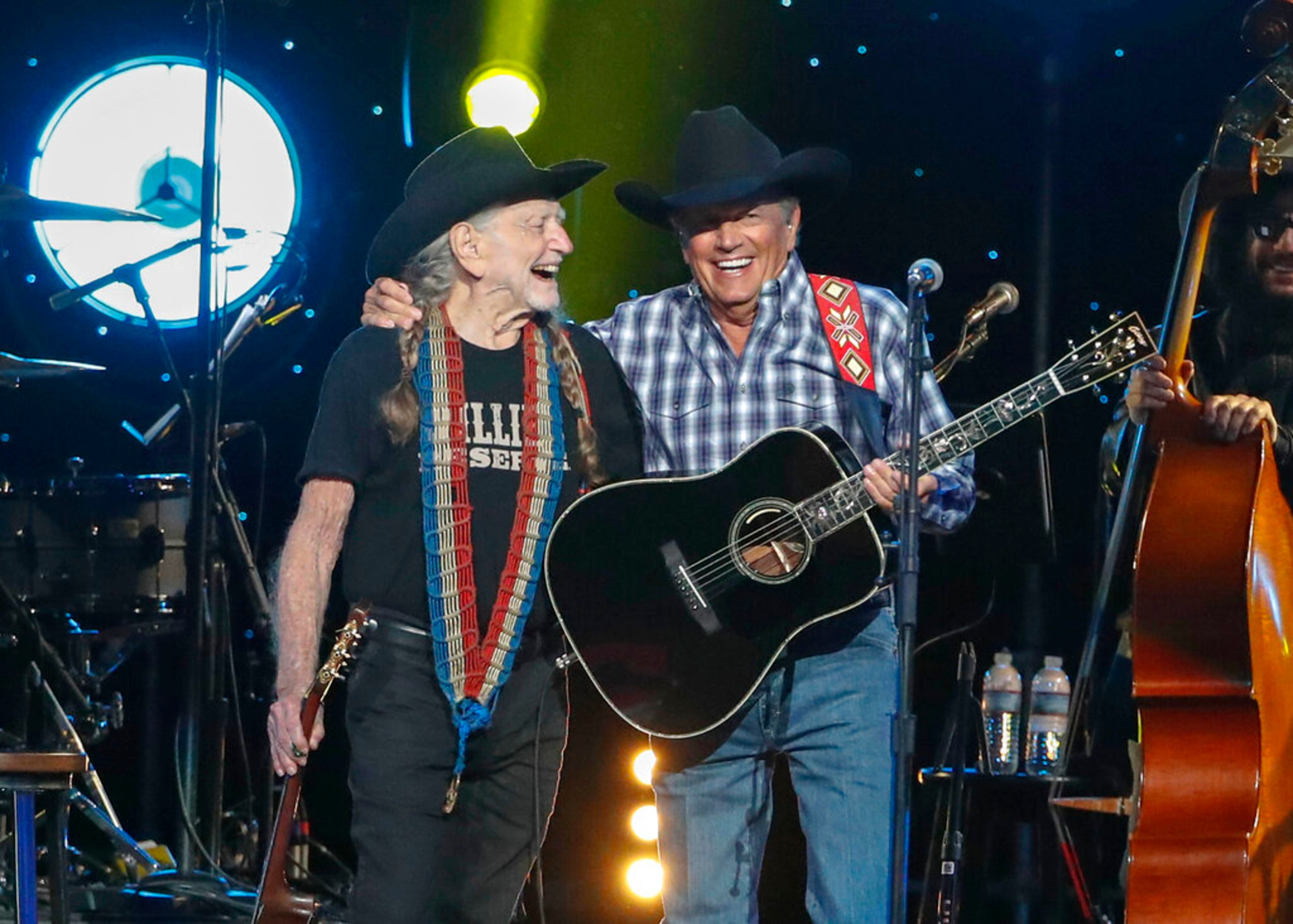 Willie Nelson, left, and George Strait perform at Willie: Life & Songs Of An American Outlaw at Bridgestone Arena on Saturday, Jan. 12, 2019, in Nashville, Tenn. (Photo by Al Wagner/Invision/AP)