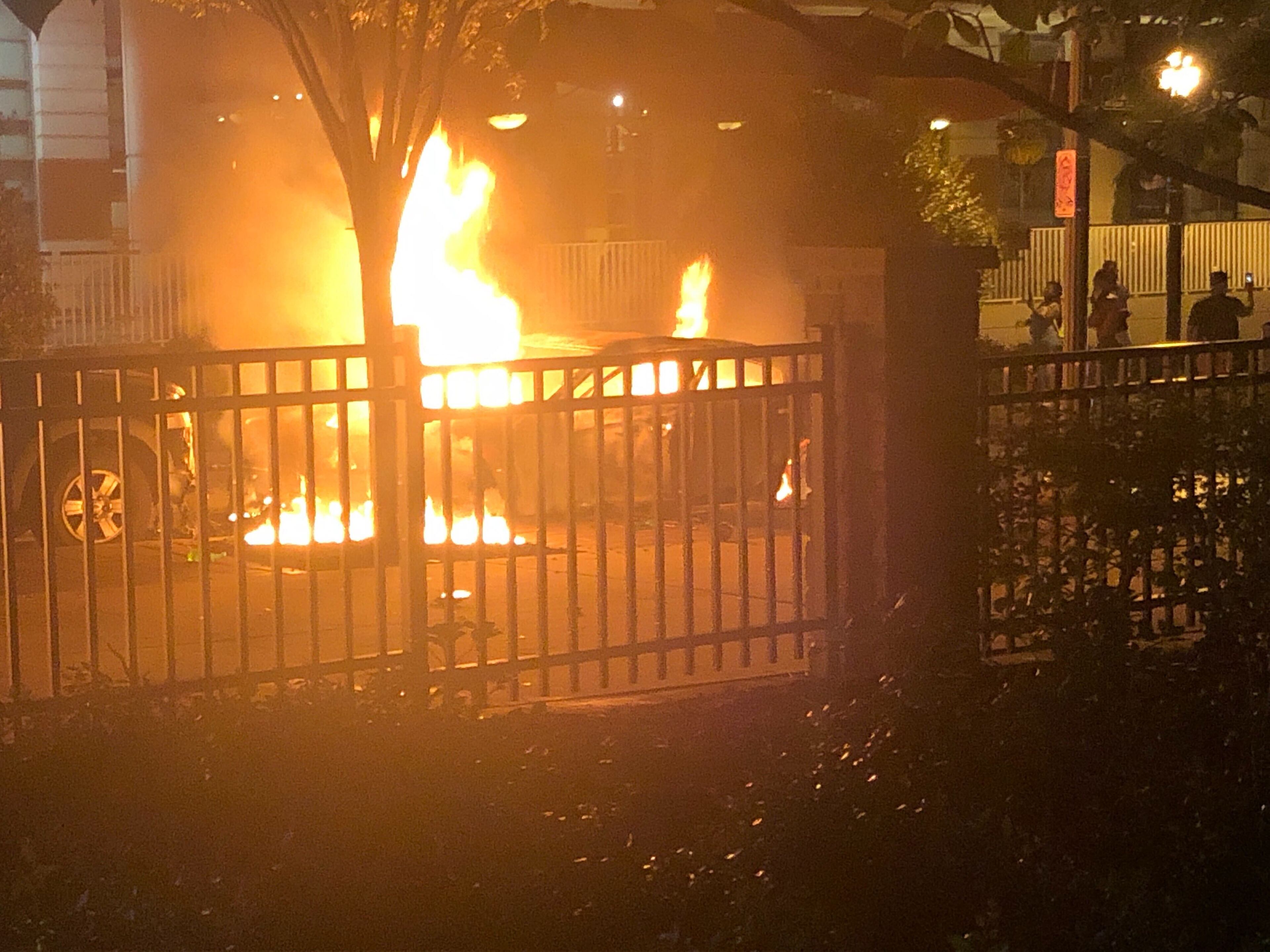 Cars burn outside Centennial Olympic Park Friday night