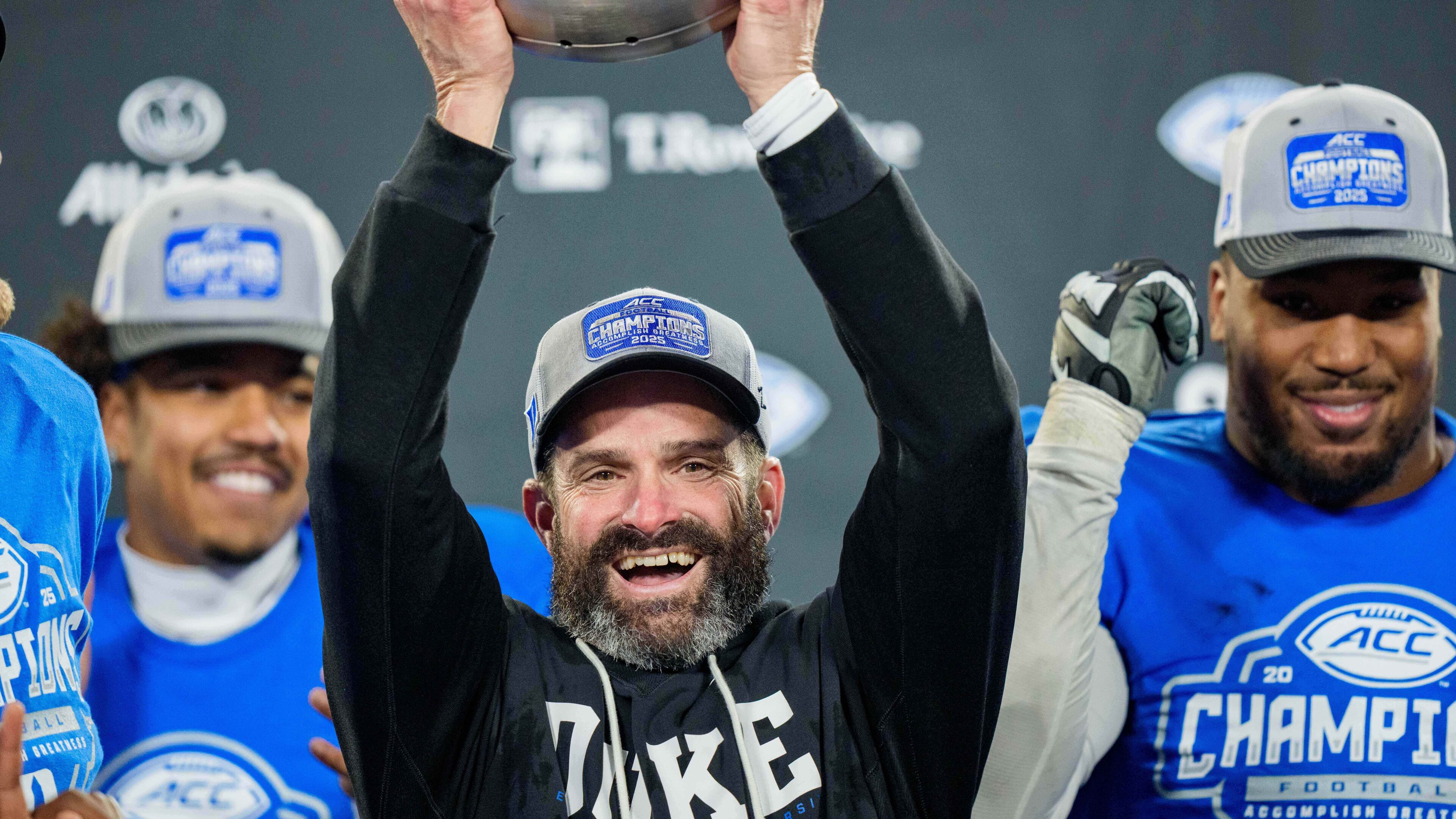 FILE - Duke head coach Manny Diaz holds up the trophy after defeating Virginia in the Atlantic Coast Conference championship NCAA college football game, Dec. 6, 2025, in Charlotte, N.C. (AP Photo/Jacob Kupferman, File)