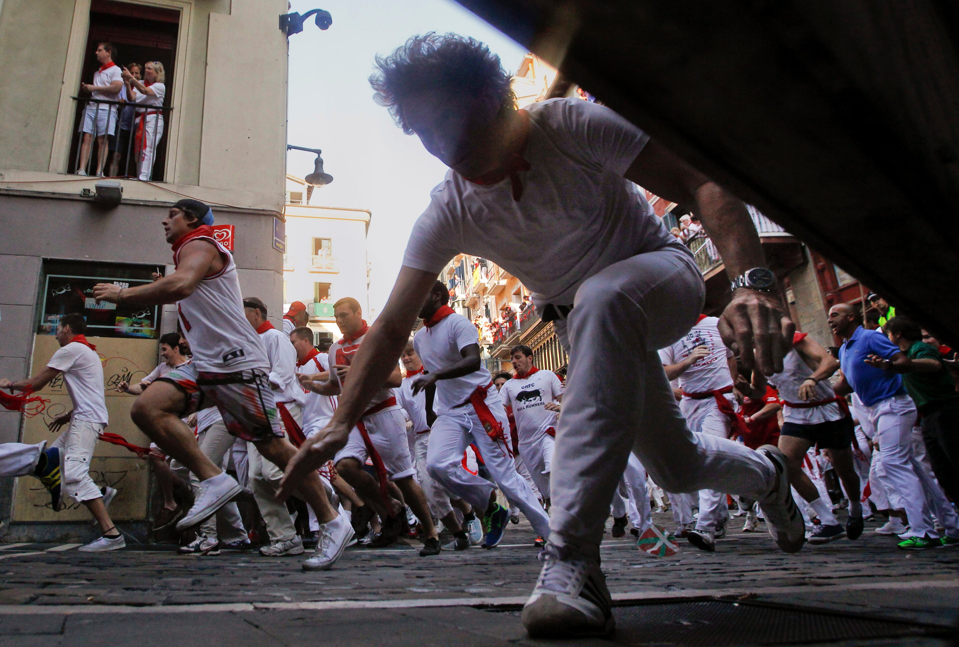 Reveler slips on the Estafeta corner during the second running of the bulls of Dolores Aguirre Ybarra ranch, at the San Fermin fiestas, in Pamplona northern Spain on Monday, July 8, 2013. (AP Photo/Alvaro Barrientos)