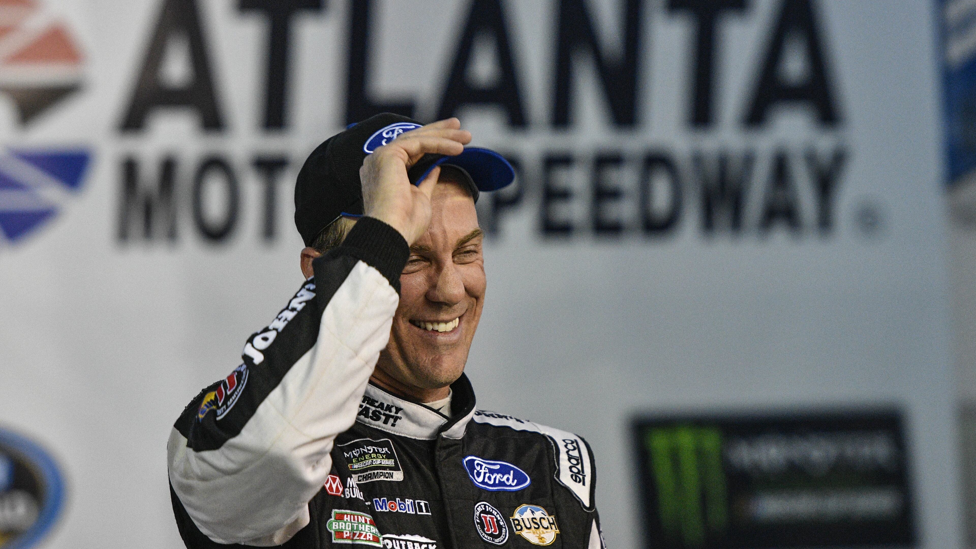 Kevin Harvick stands in Victory Lane after winning the pole for the NASCAR Monster Energy Cup auto race at Atlanta Motor Speedway in Hampton, Ga., Friday, March 3, 2017. (AP Photo/John Amis)