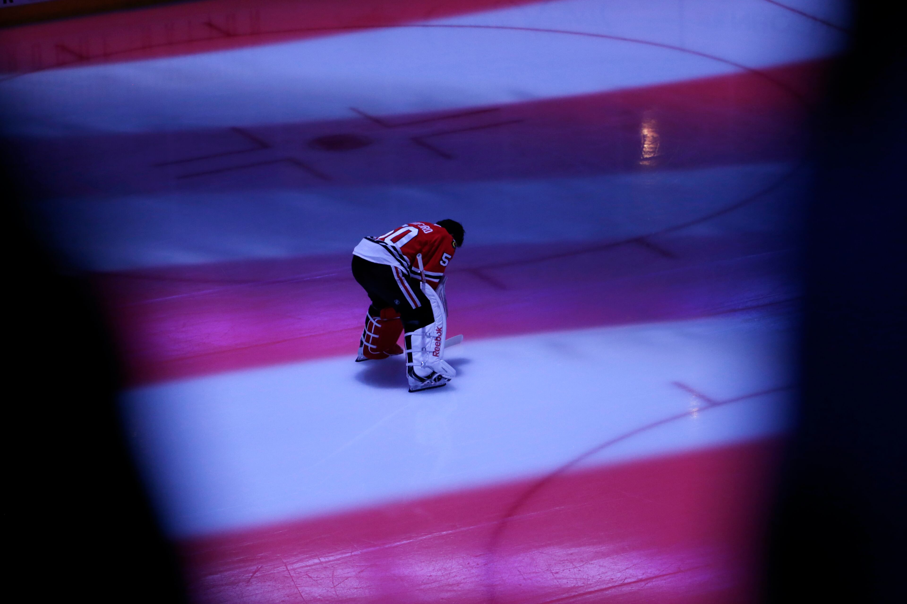 Chicago Blackhawks goalie Corey Crawford pauses during the national anthem before the start of Game 3 of the NHL hockey Stanley Cup Final against the Tampa Bay Lightning on Monday, June 8, 2015, in Chicago. (AP Photo/Charles Rex Arbogast)