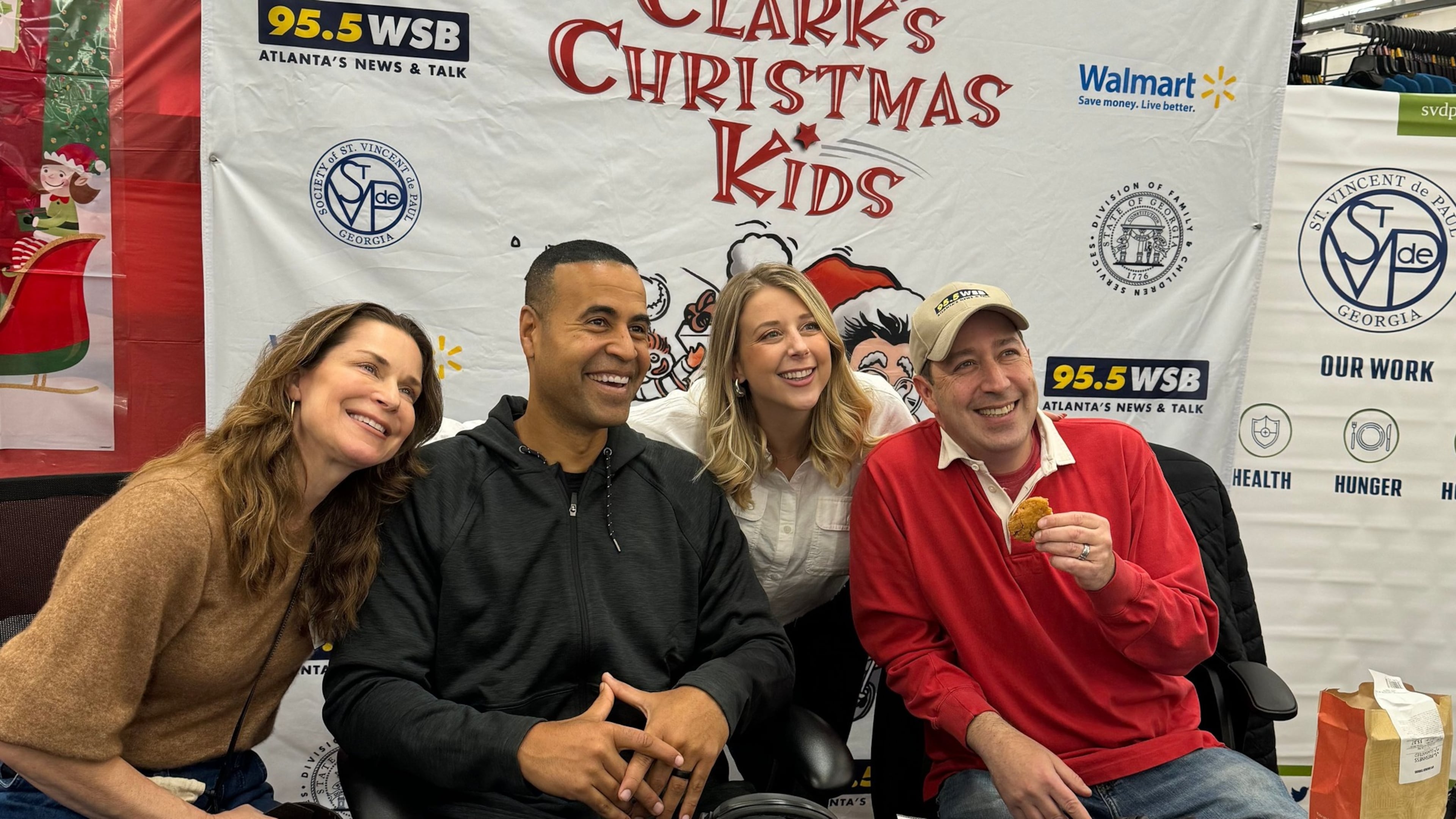 Lane Howard, Fred Blankenship, Rebecca Howard Jennings and Mark Arum pose at a local Wal-Mart durng the 33rd annual Clark's Christmas Kids event. KEN CHARLES