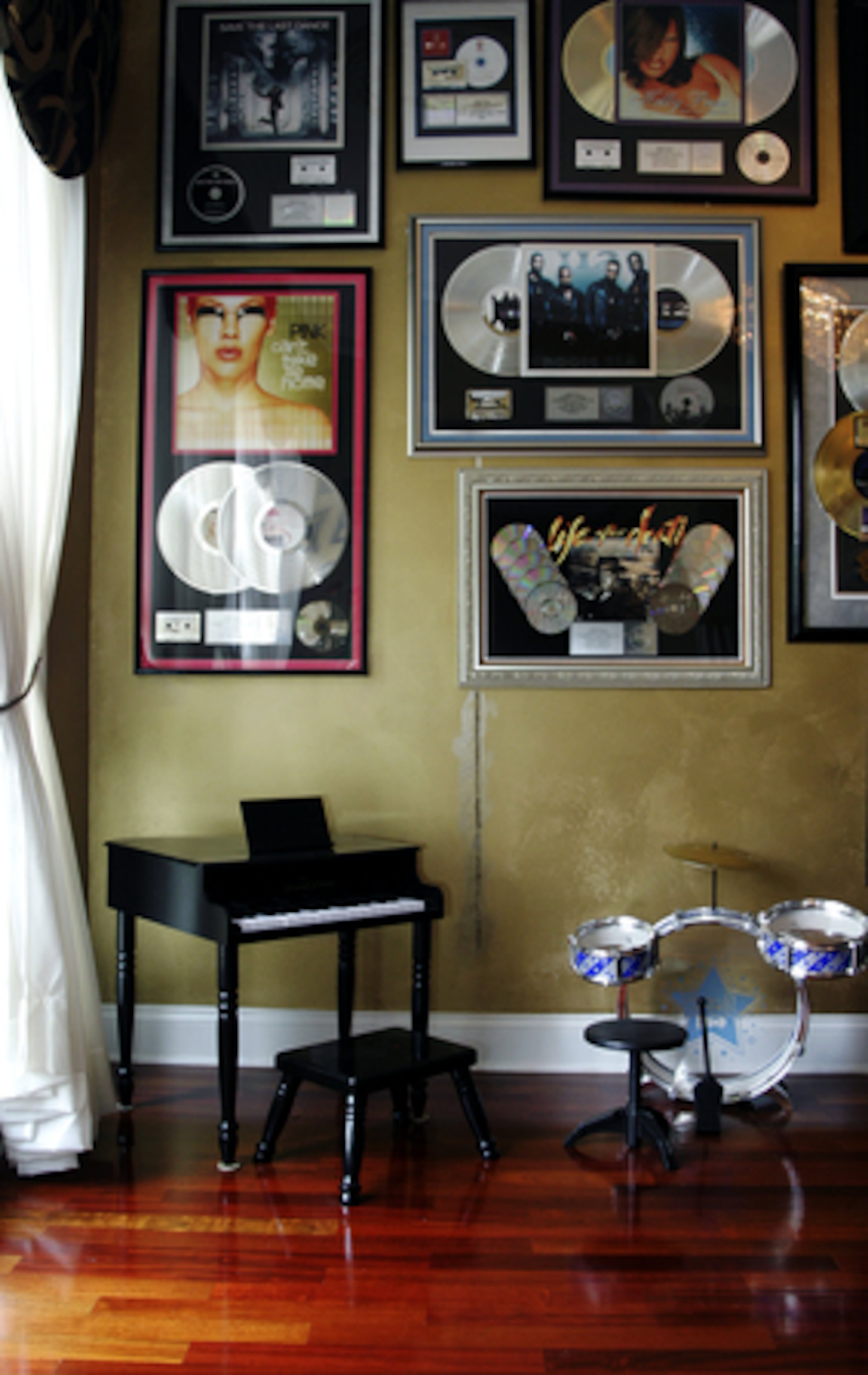 Quinnes Jr. likes to play his piano and bang on his drum set in his father's piano room.