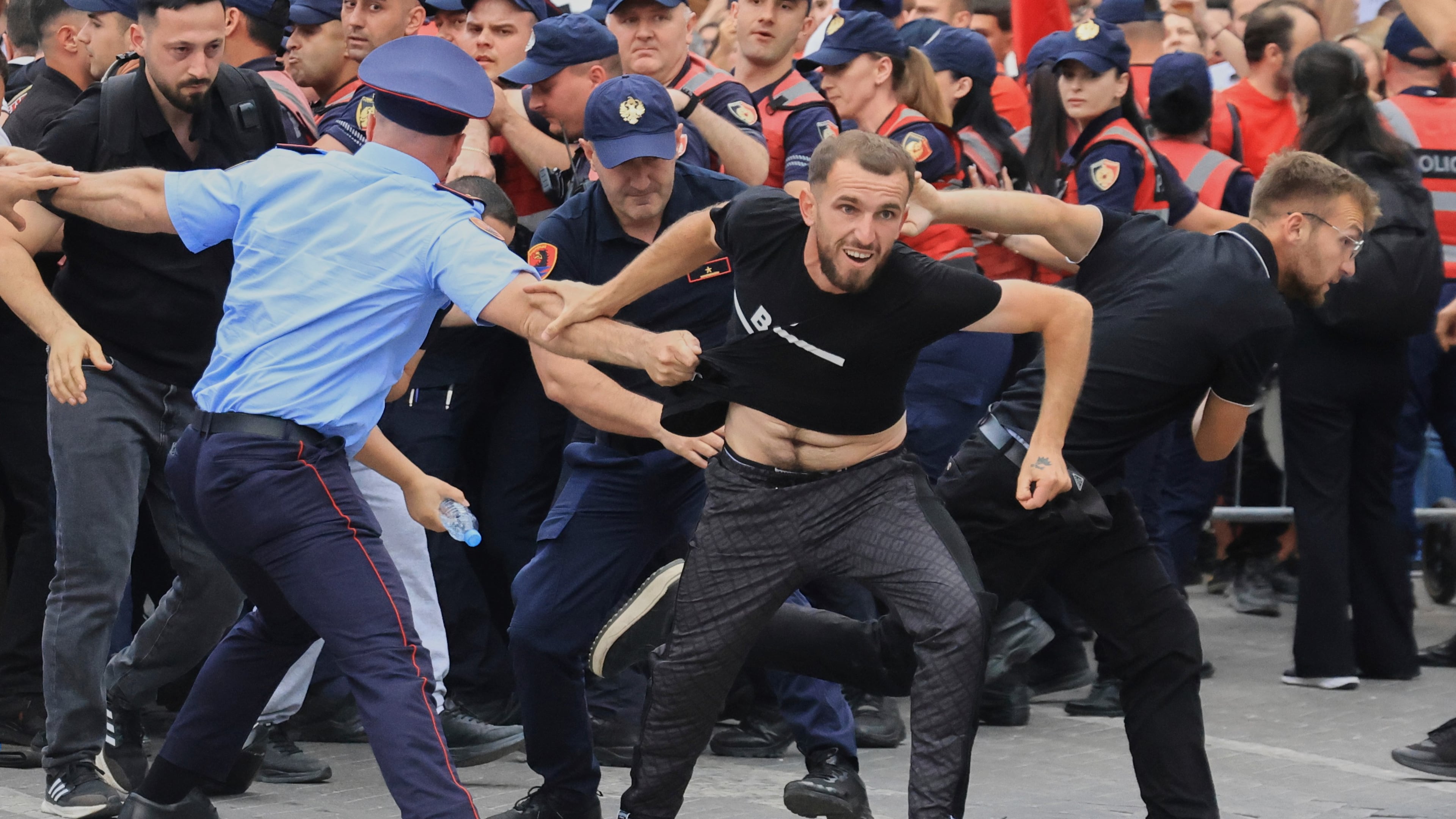 Protesters scuffle with police officers blocking a street during a demonstration in Tirana, Albania, Wednesday, June 3, 2026, opposing a luxury coastal development project linked to Jared Kushner and Ivanka Trump over concerns about environmental impacts and transparency.(AP Photo/Hameraldi Agolli)
