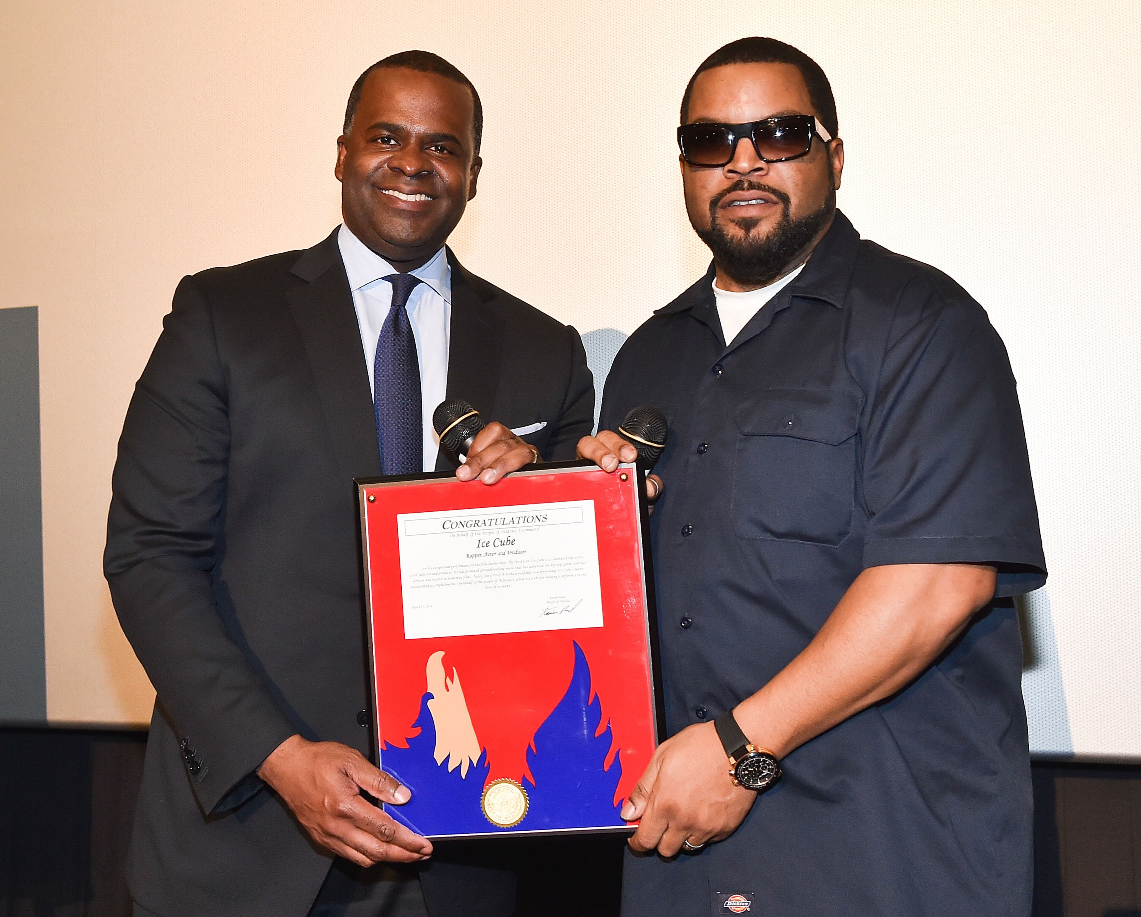Actor/rapper Ice Cube (R) accepts the City of Atlanta Phoenix Award from Atlanta Mayor Kasim Reed (L) at "Barbershop: The Next Cut" advanced Atlanta VIP screening at Regal Atlantic Station on March 17, 2016 in Atlanta, Georgia. (Photo by Paras Griffin/Getty Images for Warner Bros)