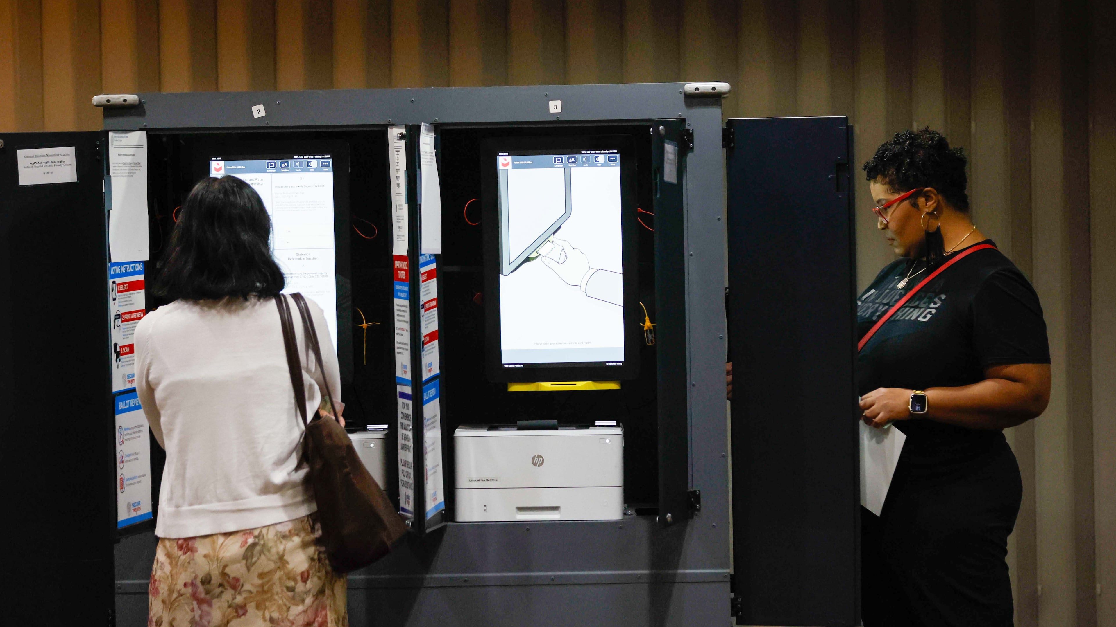 Fulton County resident Andrea Martinez (left) is seen casting her ballot inside the Antioch Baptist Church in Atlanta during Election Day on Tuesday, Nov. 5, 2024.
(Miguel Martinez/AJC)
