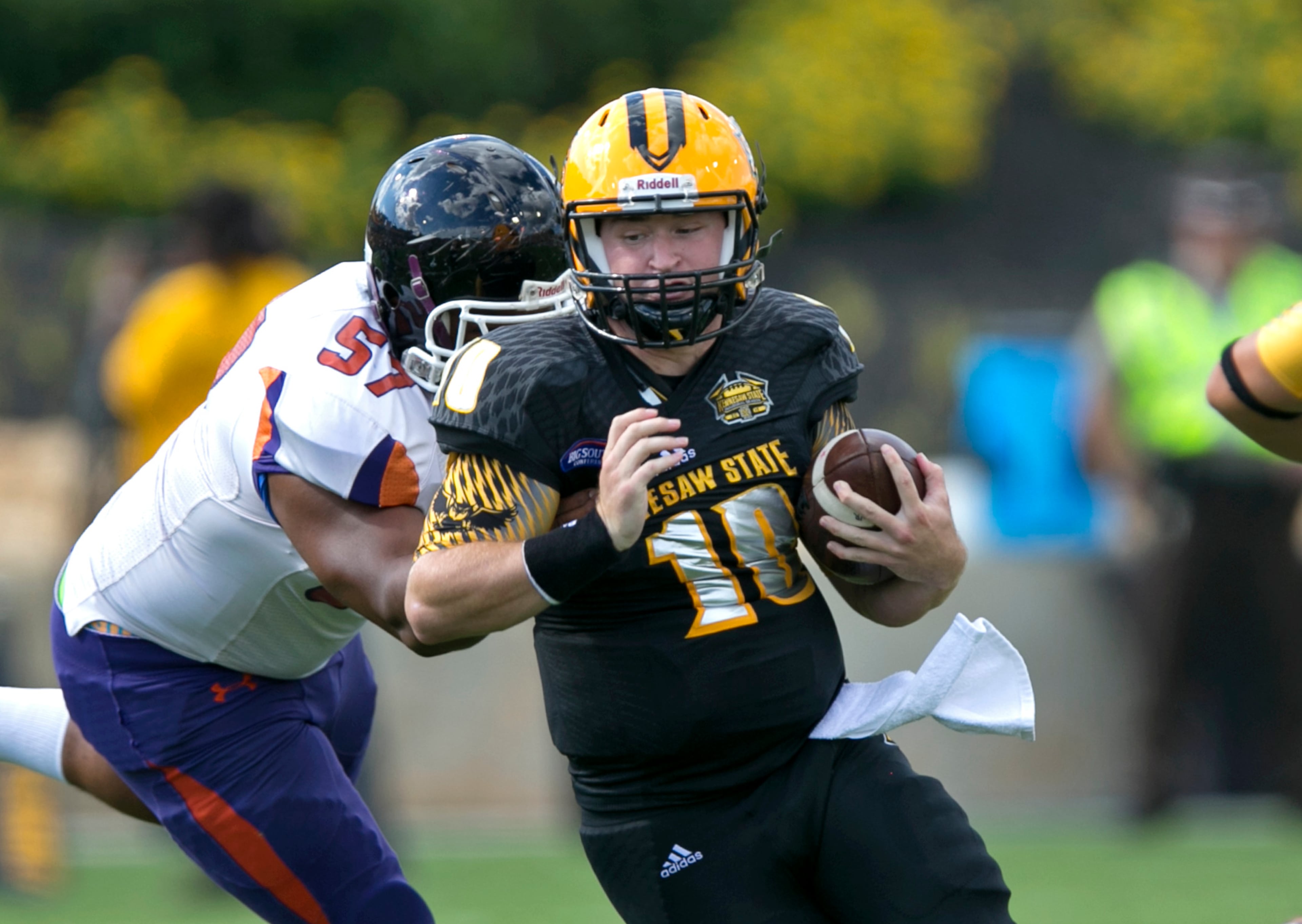September 12, 2015 - Kennesaw, Ga: Kennesaw State University quarterback Trey White (10) runs against Edward Waters defensive lineman Juan Cruz (57) in the first quarter at Fifth Third Bank Stadium, Saturday, September 12, 2015, in Kennesaw, Ga.. This is the first home game of KSU's inaugural football season. PHOTO / JASON GETZ