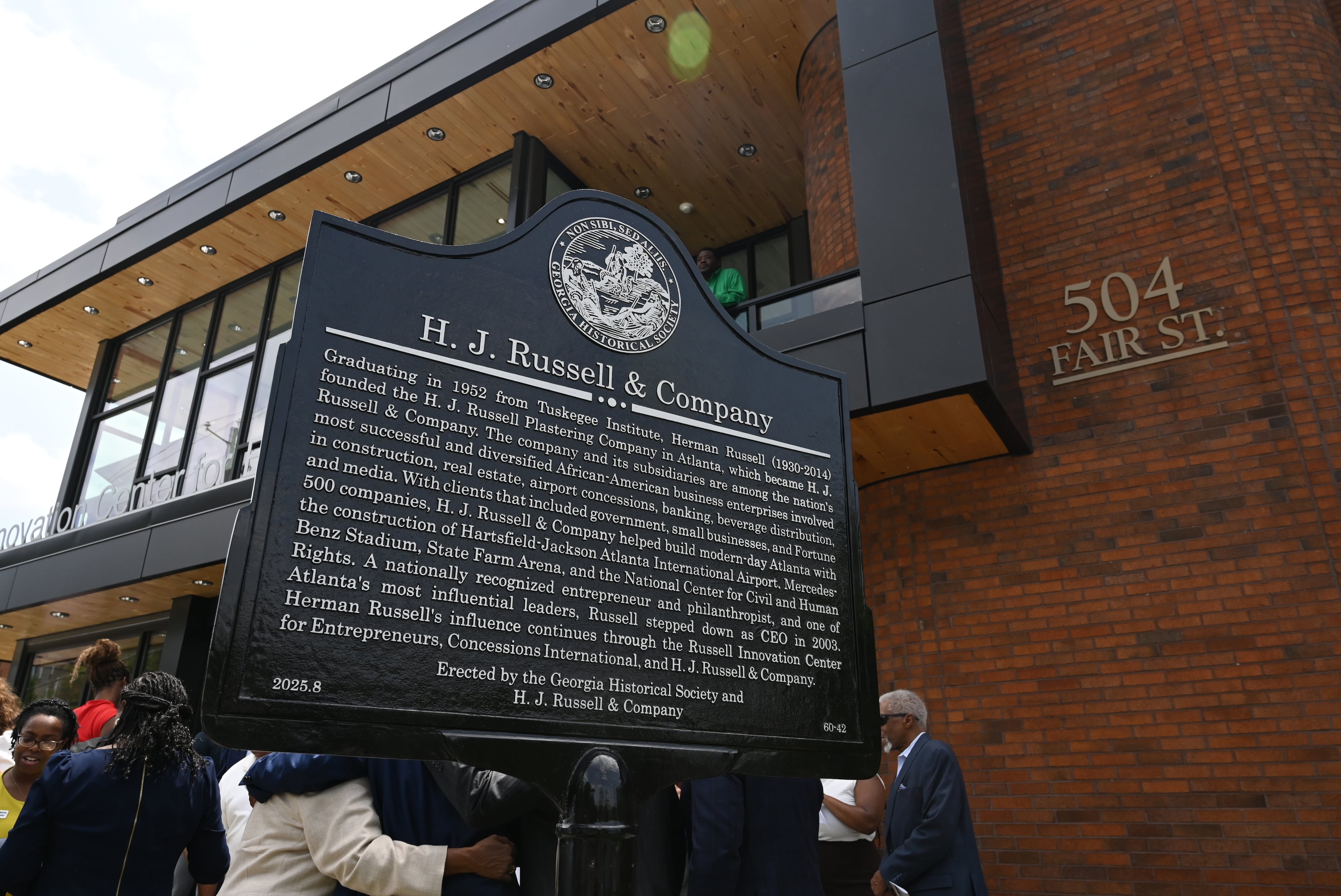 The Georgia Historical Society marker commemorating H.J. Russell & Co.’s original headquarters, reads: "Graduating in 1952 from Tuskegee Institute, Herman Russell (1930-2014) founded the H.J. Russell Plastering Company in Atlanta, which became H.J. Russell & Company. The company and its subsidiaries are among the nation’s most successful and diversified African-American business enterprises involved in construction, real estate, airport concessions, banking, beverage distribution, and media. With clients that included government, small businesses, and Fortune 500 companies, H.J. Russell & Company helped build modern-day Atlanta with the construction of Hartsfield-Jackson Atlanta International Airport, Mercedes Benz-Stadium, State Farm Arena, and the National Center for Civil and Human Rights. A nationally recognized entrepreneur and philanthropist, and one of Atlanta’s most influential leaders, Russell stepped down as CEO in 2003. Herman Russell’s influence continues through the Russell Innovation Center for Entrepreneurs, Concessions International, and H.J. Russell & Company.
Erected by the Georgia Historical Society and H.J. Russell & Company." (Hyosub Shin/AJC)