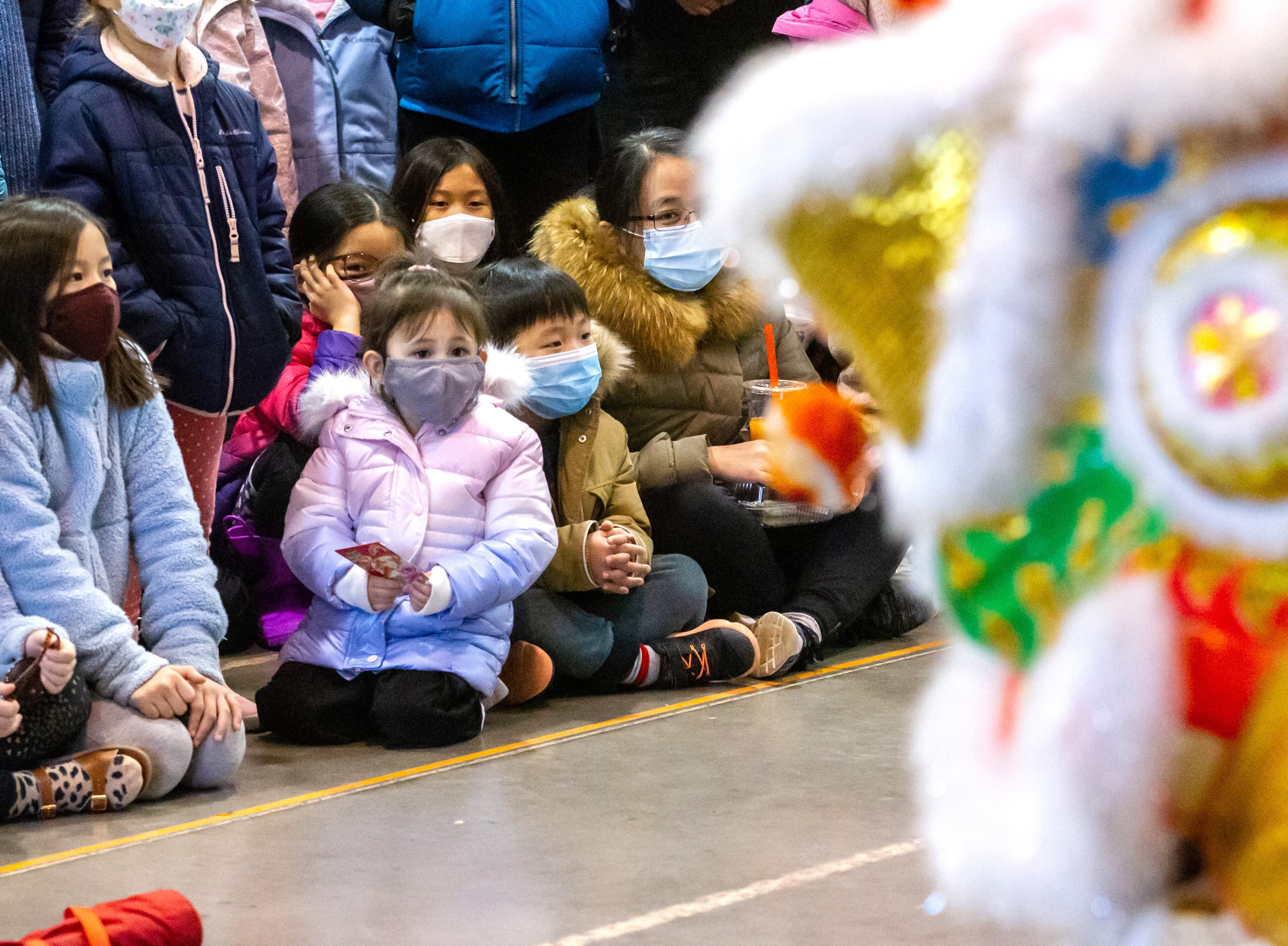 Children watch the Lion Dance during Decatur's first Lunar New Year celebration at Legacy Park on Saturday, January 29, 2022. STEVE SCHAEFER FOR THE ATLANTA JOURNAL-CONSTITUTION