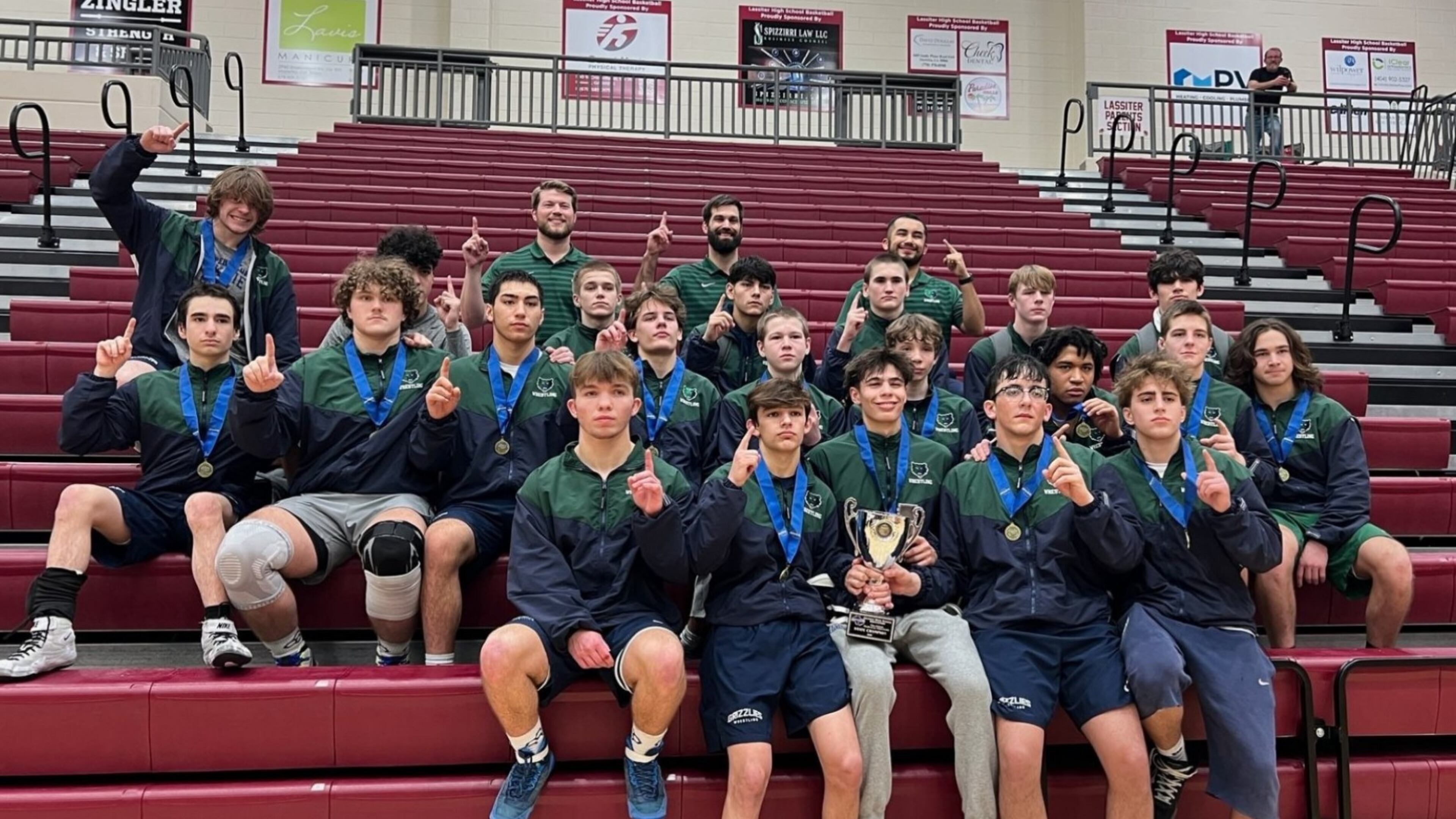 Creekview wrestlers celebrate with the trophy after defeating Glynn Academy 37-33 to win the Class 5A team duals championship at Lassiter High School on Jan. 18, 2025. Georgia High School Association photo.