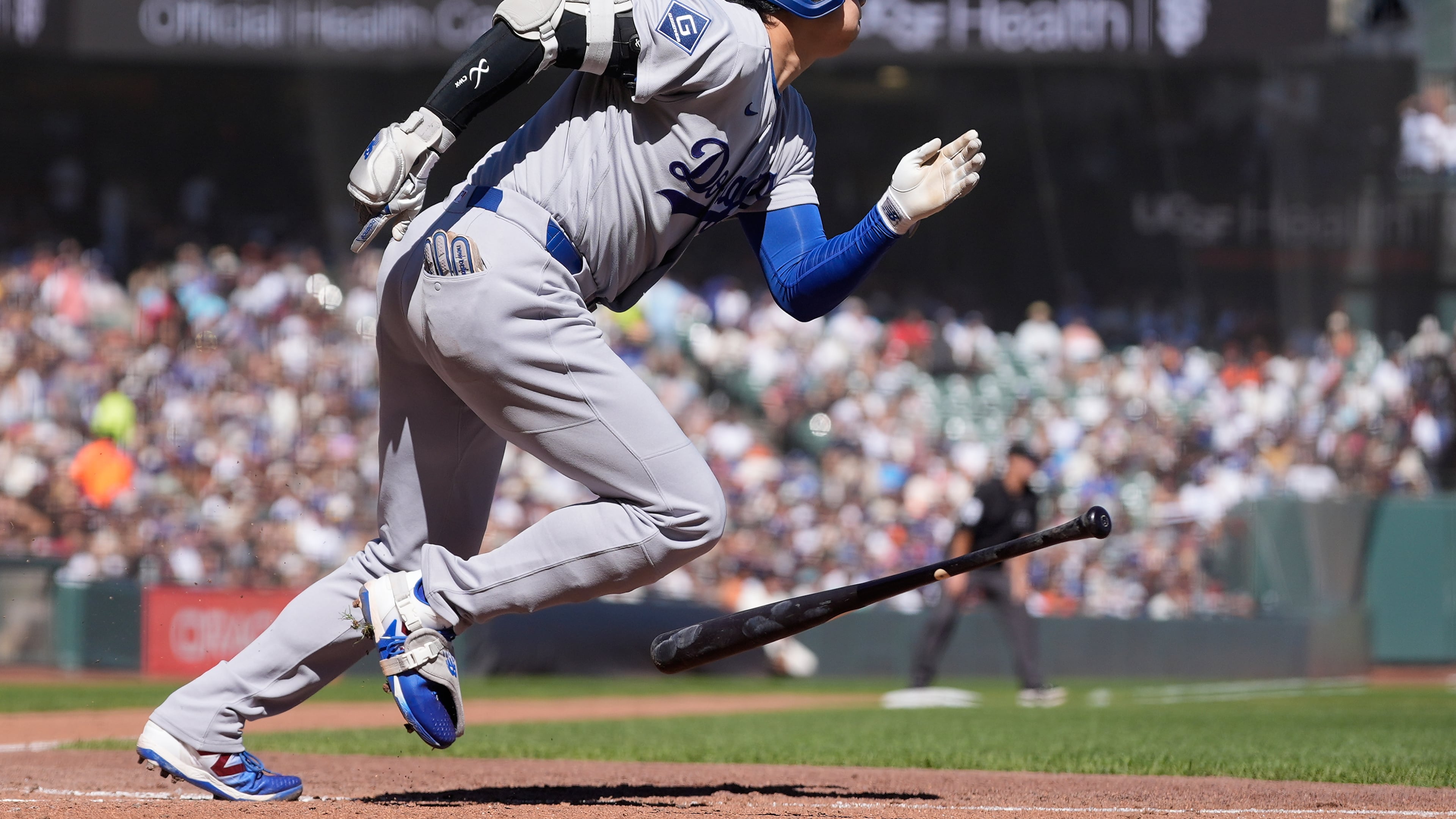 Los Angeles Dodgers designated hitter Shohei Ohtani runs to first base after hitting a single during the fifth inning of a baseball game against the San Francisco Giants, Saturday, Sept. 26, 2026, in San Francisco. (AP Photo/Jeff Chiu)